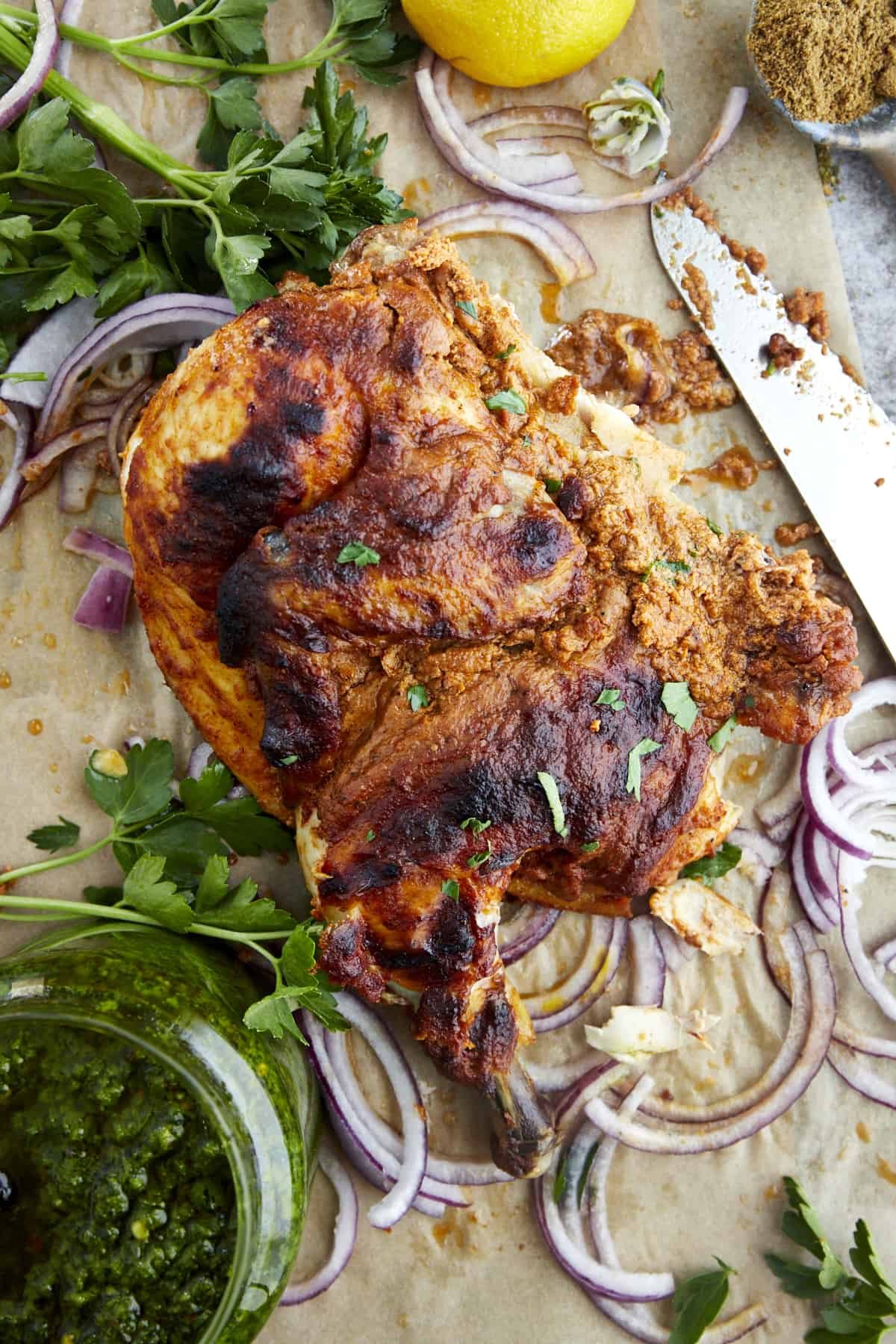 A piece of a roasted whole chicken with warm MIddle Eastern spices.