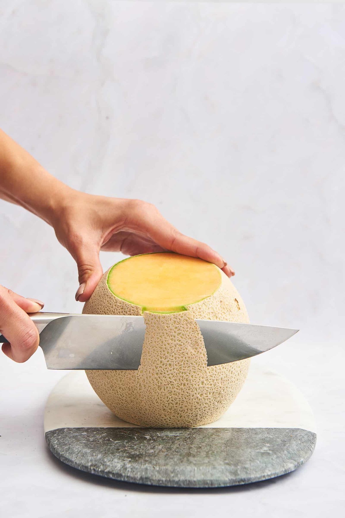Slicing off the rind.