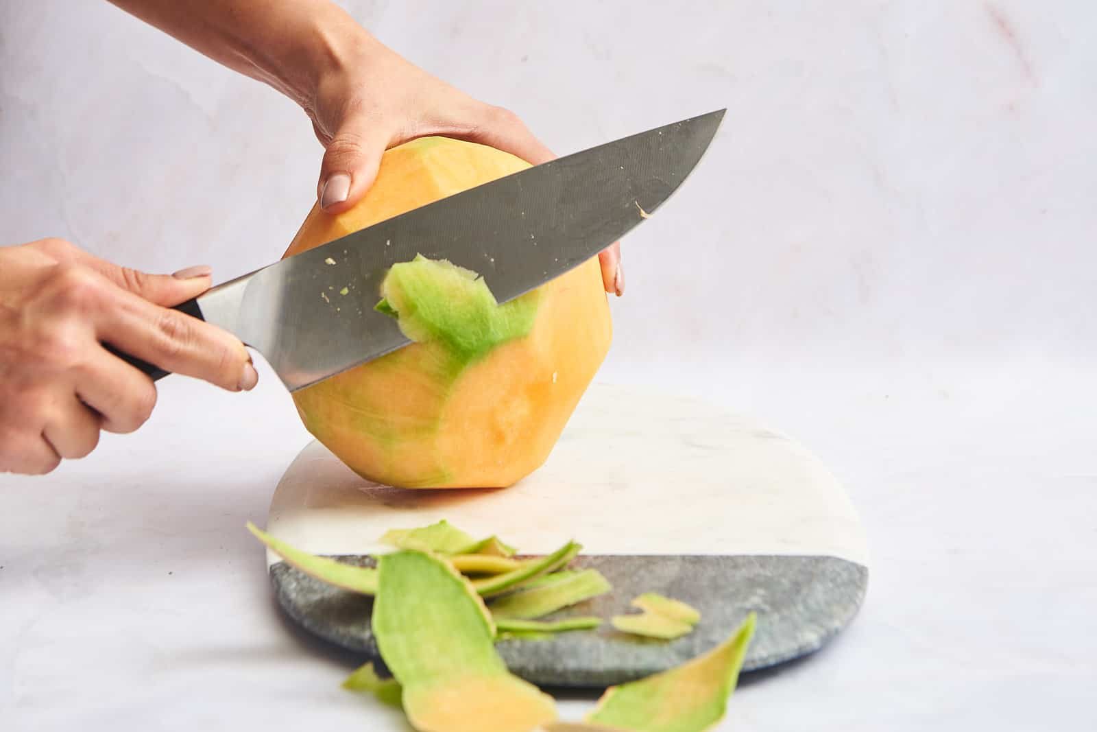 Slicing off rind.