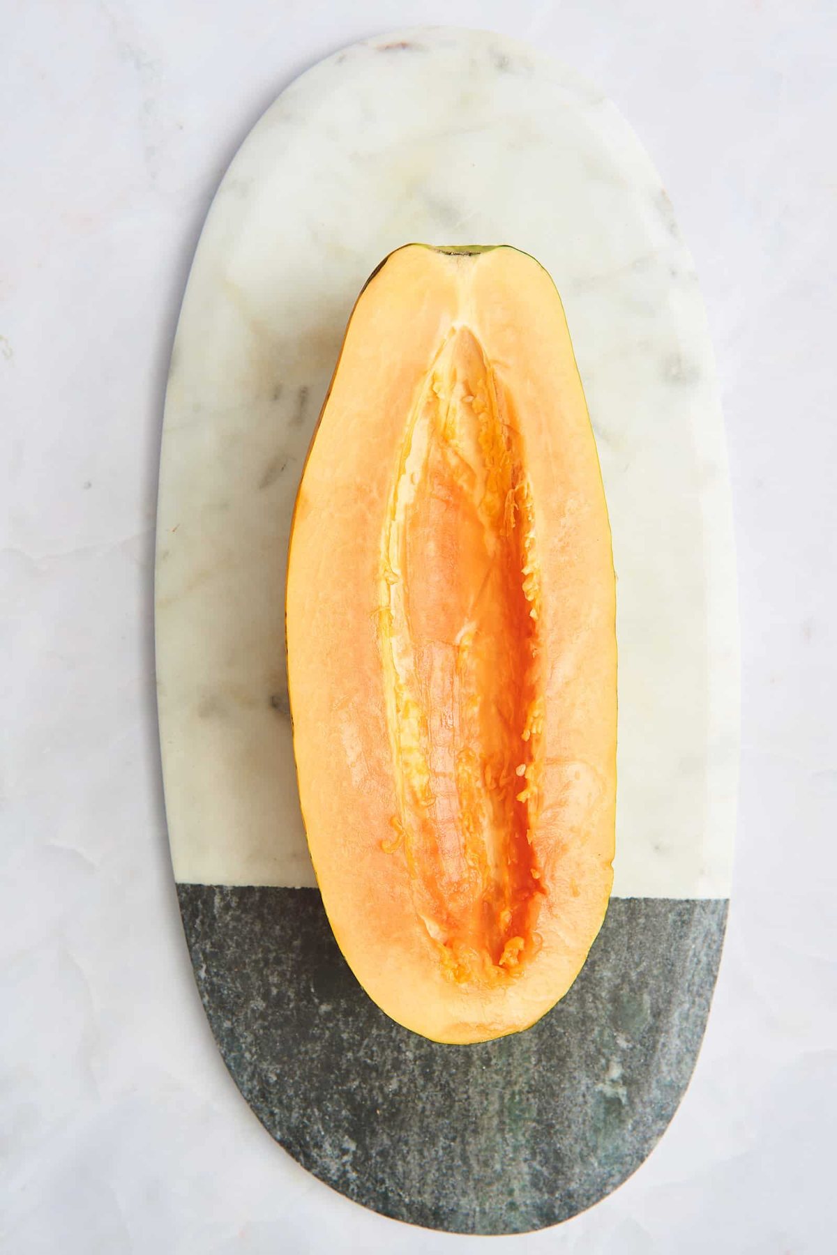 Half a papaya with the seeds removed.