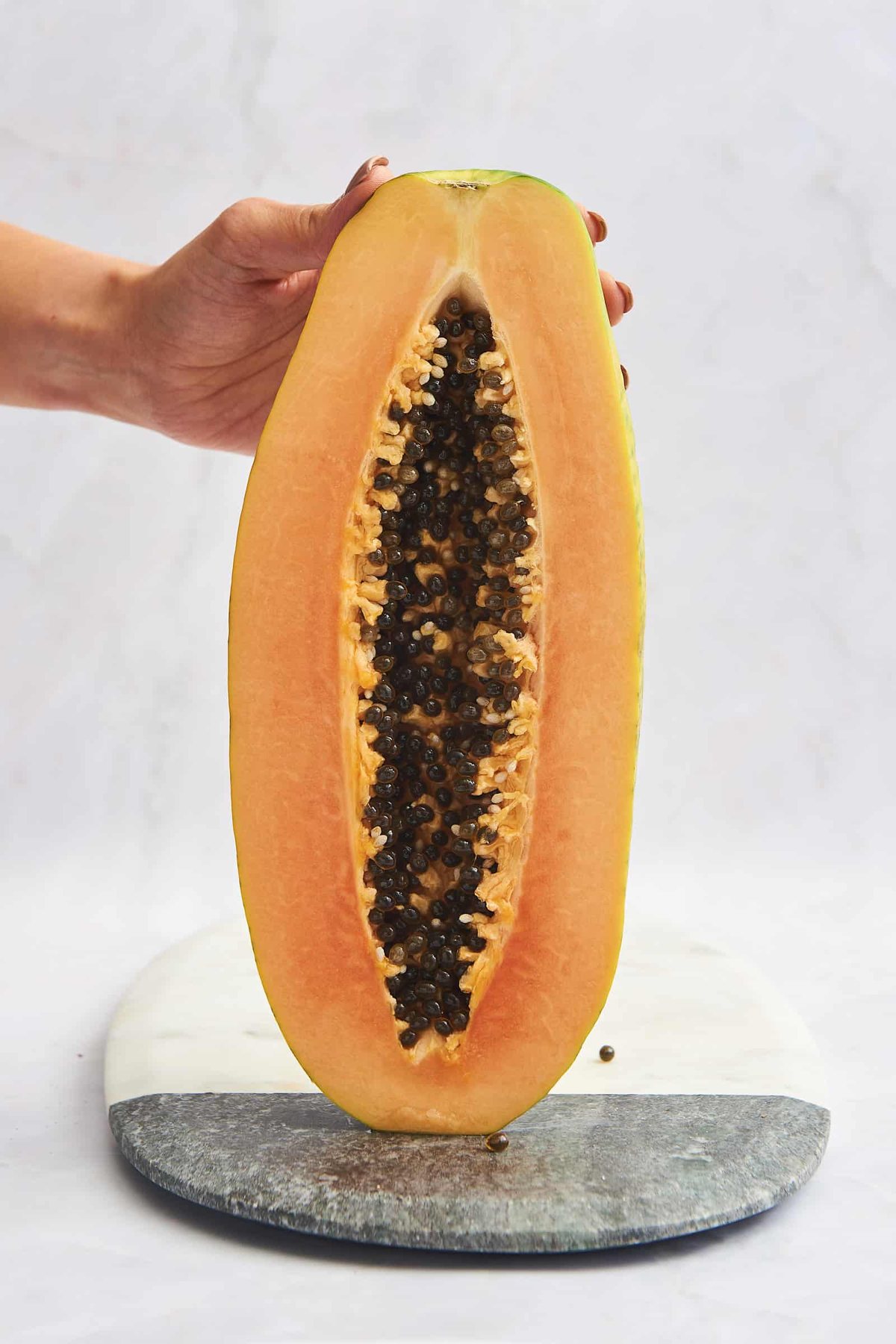 A halved papaya with black seeds in the center.