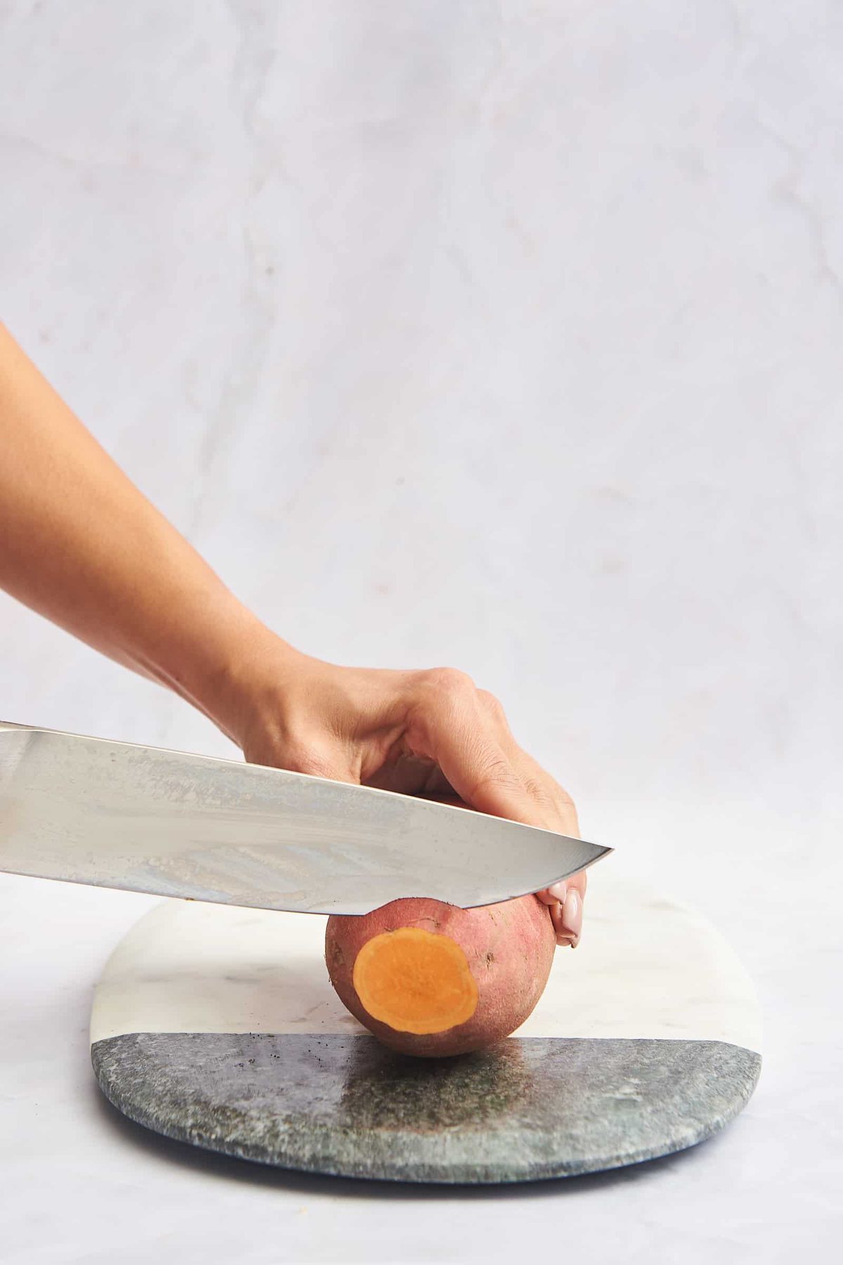 The end of a sweet potato being trimmed.