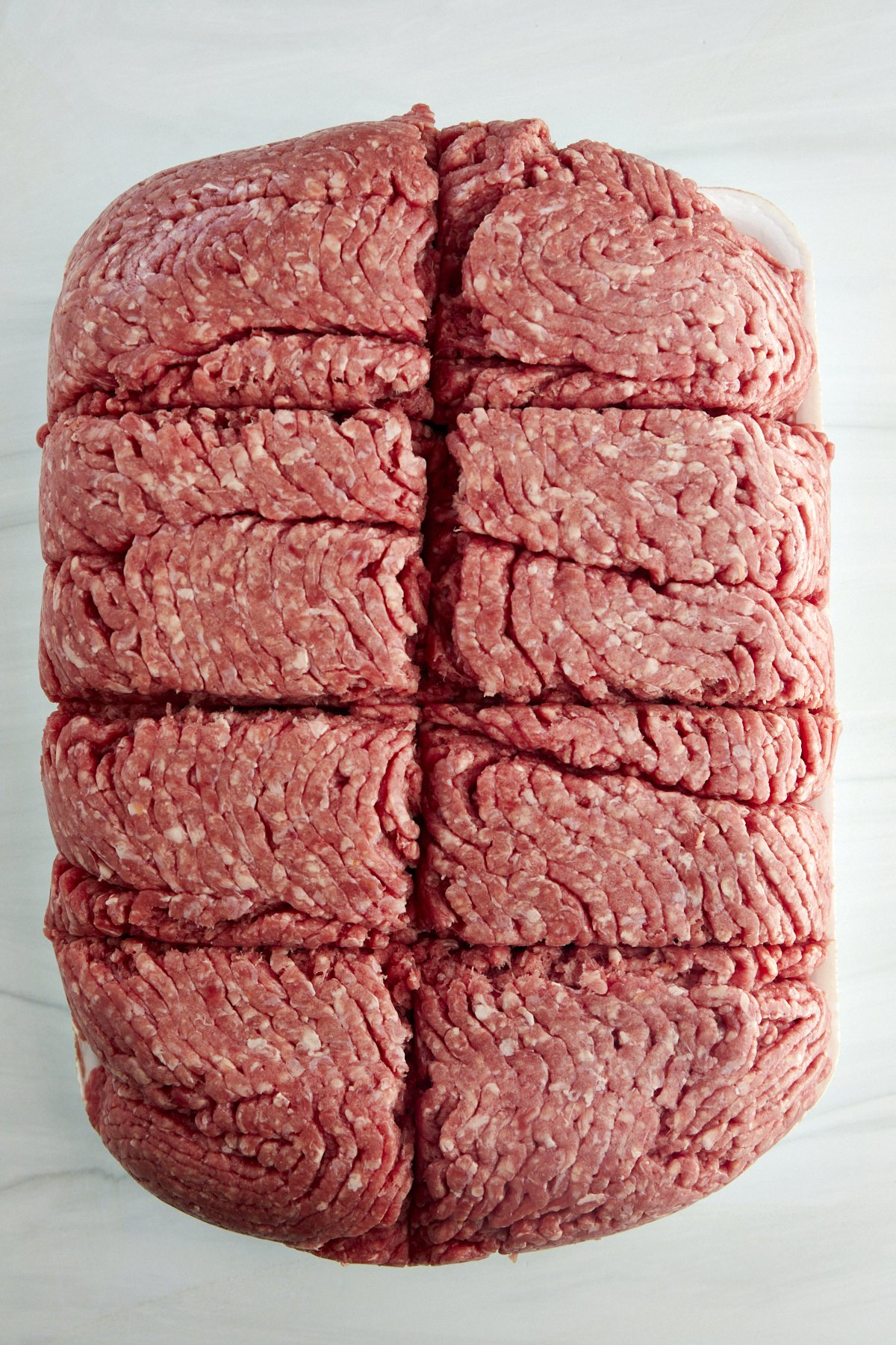 Raw ground beef sectioned into 1 pound portions.