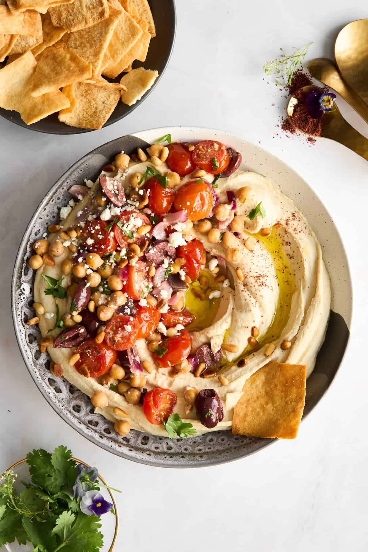 Hummus with Roasted Tomatoes and Olives at the Table