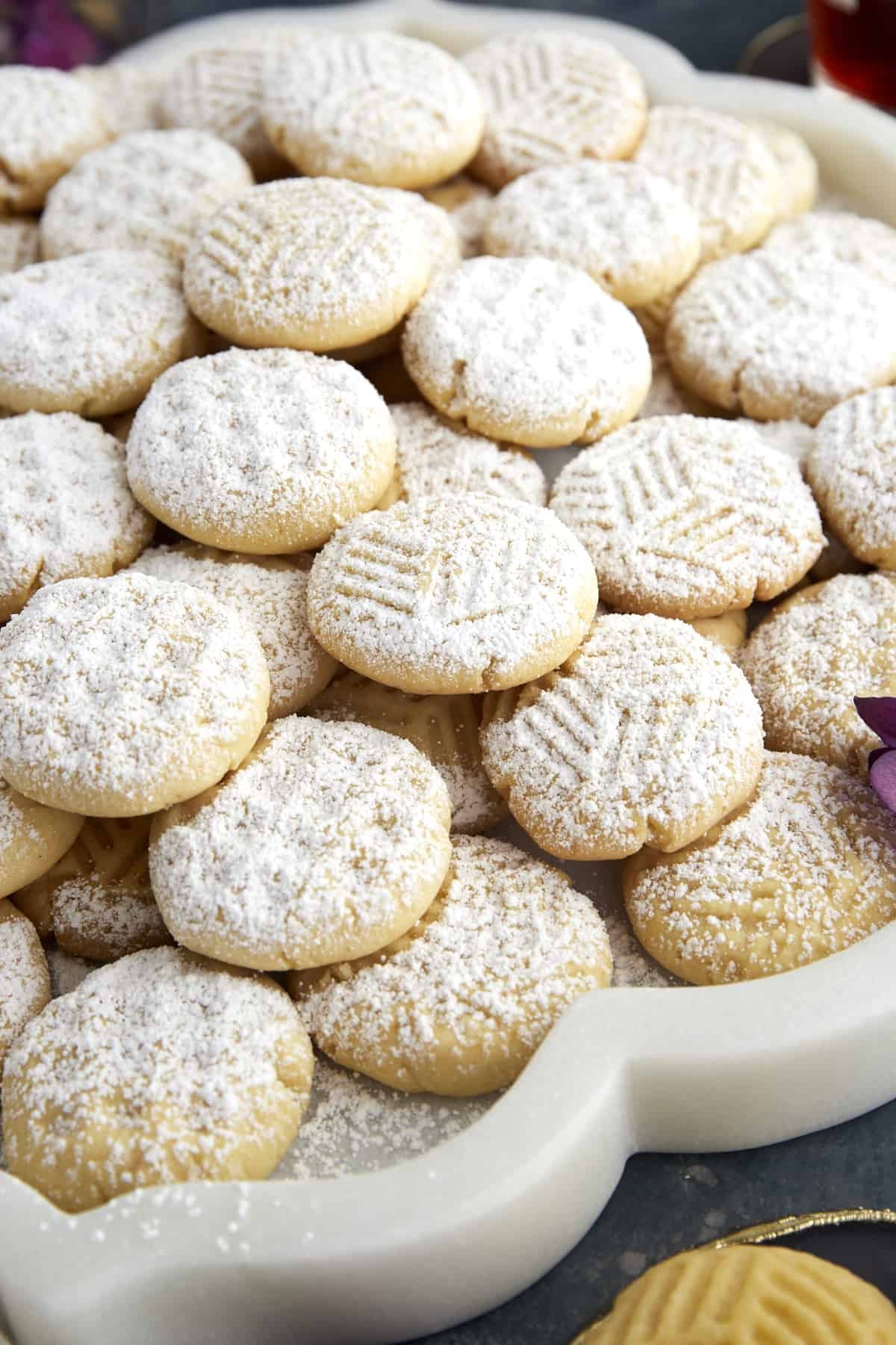 Kahk Cookies with geometric designs topped with powdered sugar.