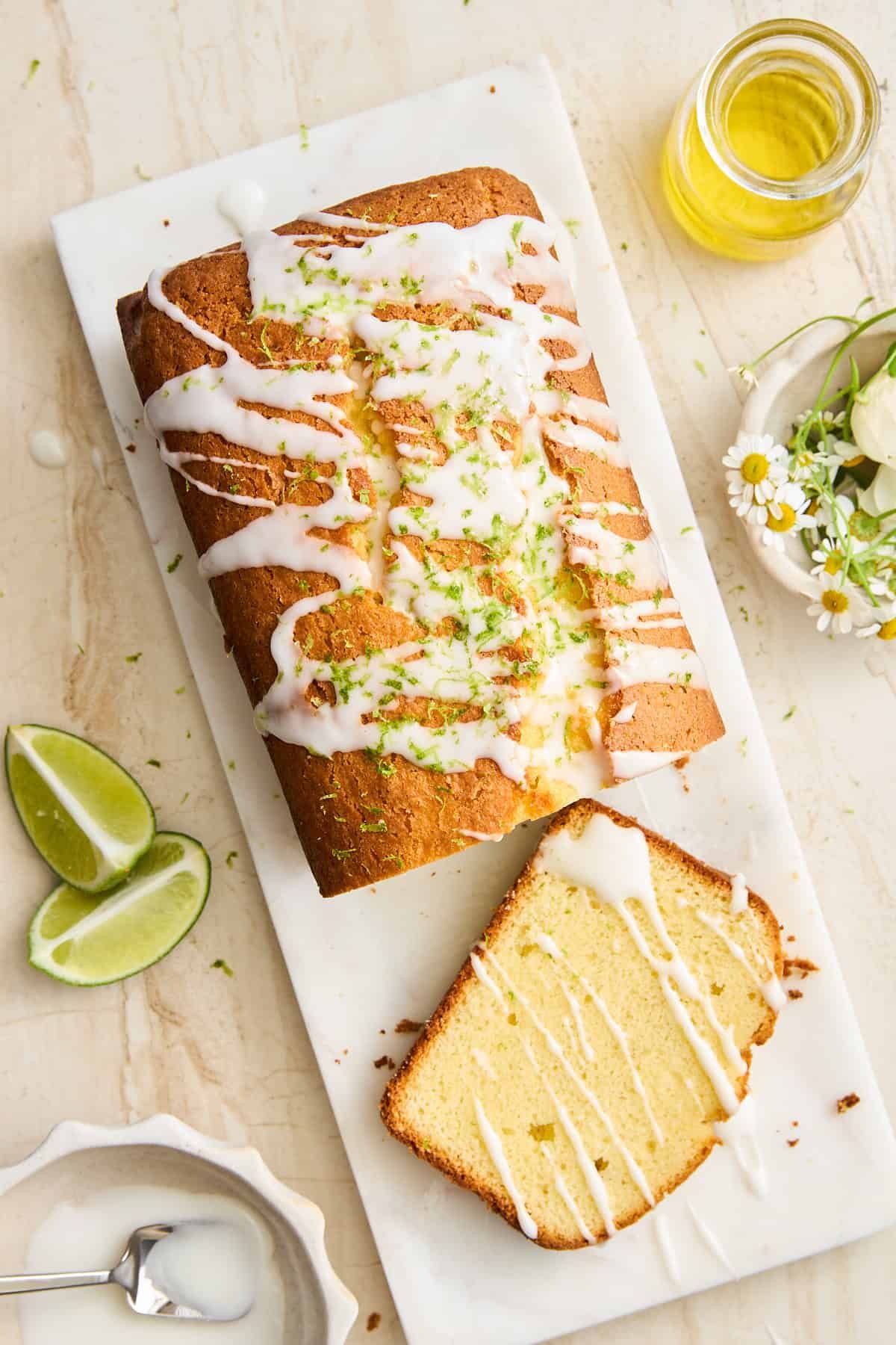 Key lime loaf on a cutting board with a slice cut.