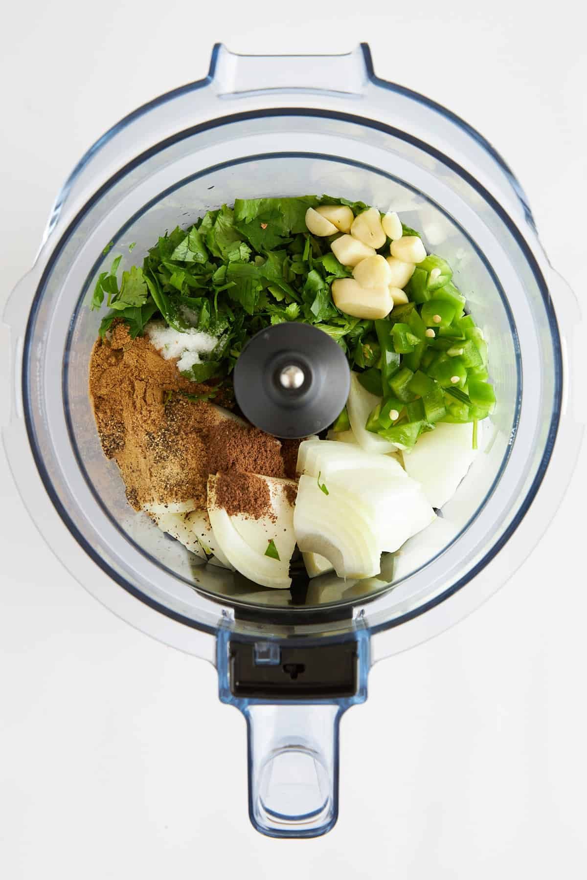 Ingredients for lamb kofta burgers in a food processor.