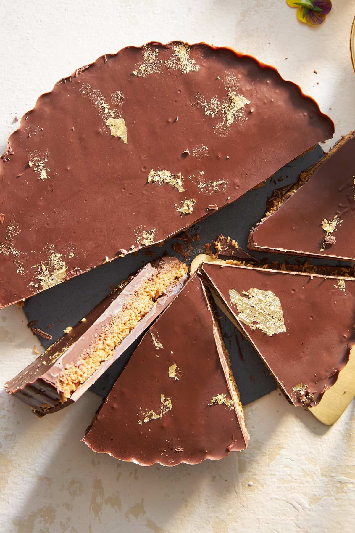 A chocolate peanut butter kunafa with four pieces sliced.