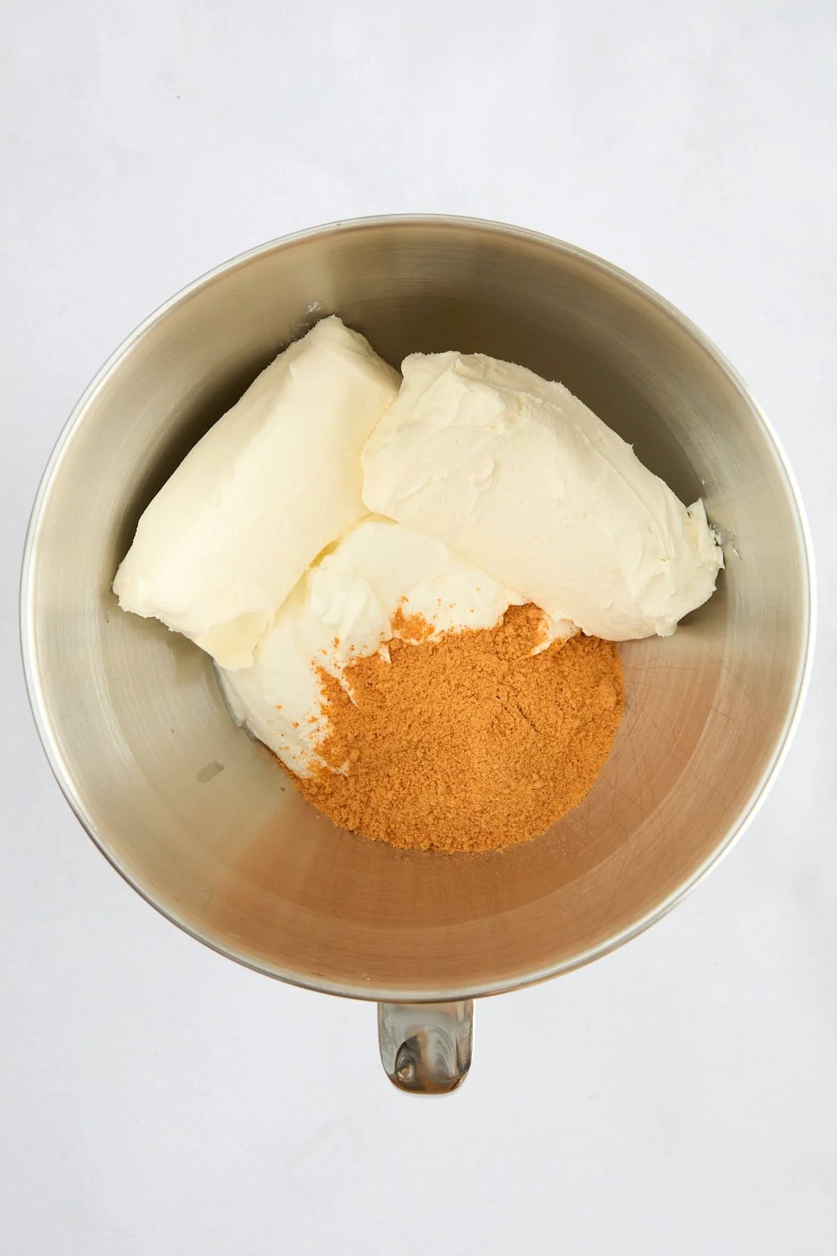 Cream cheese, sour cream, and seasoning in a bowl