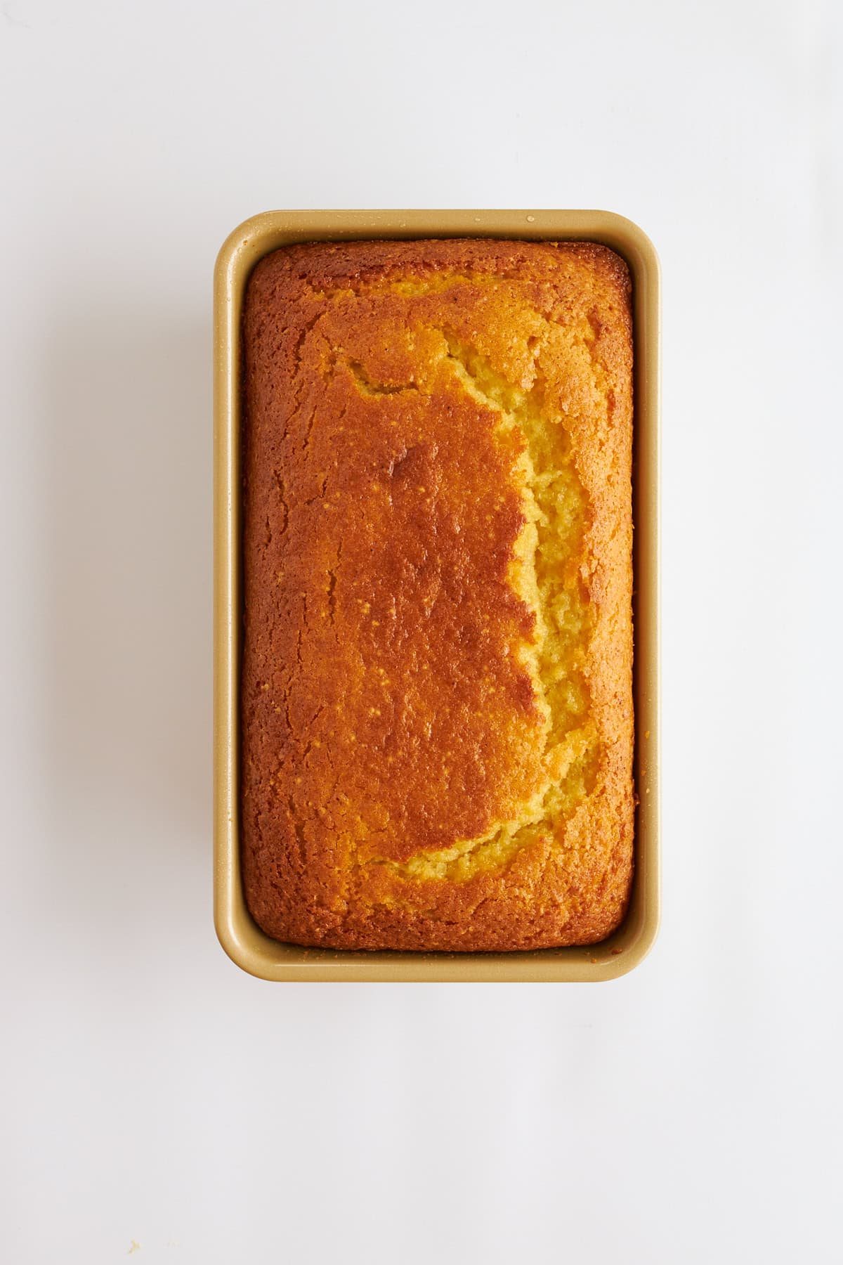 Baked lemon bread in a loaf pan.