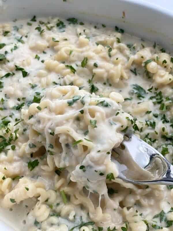 Parmesan Lemon Garlic Pasta in a baking dish being scooped up with a spoon
