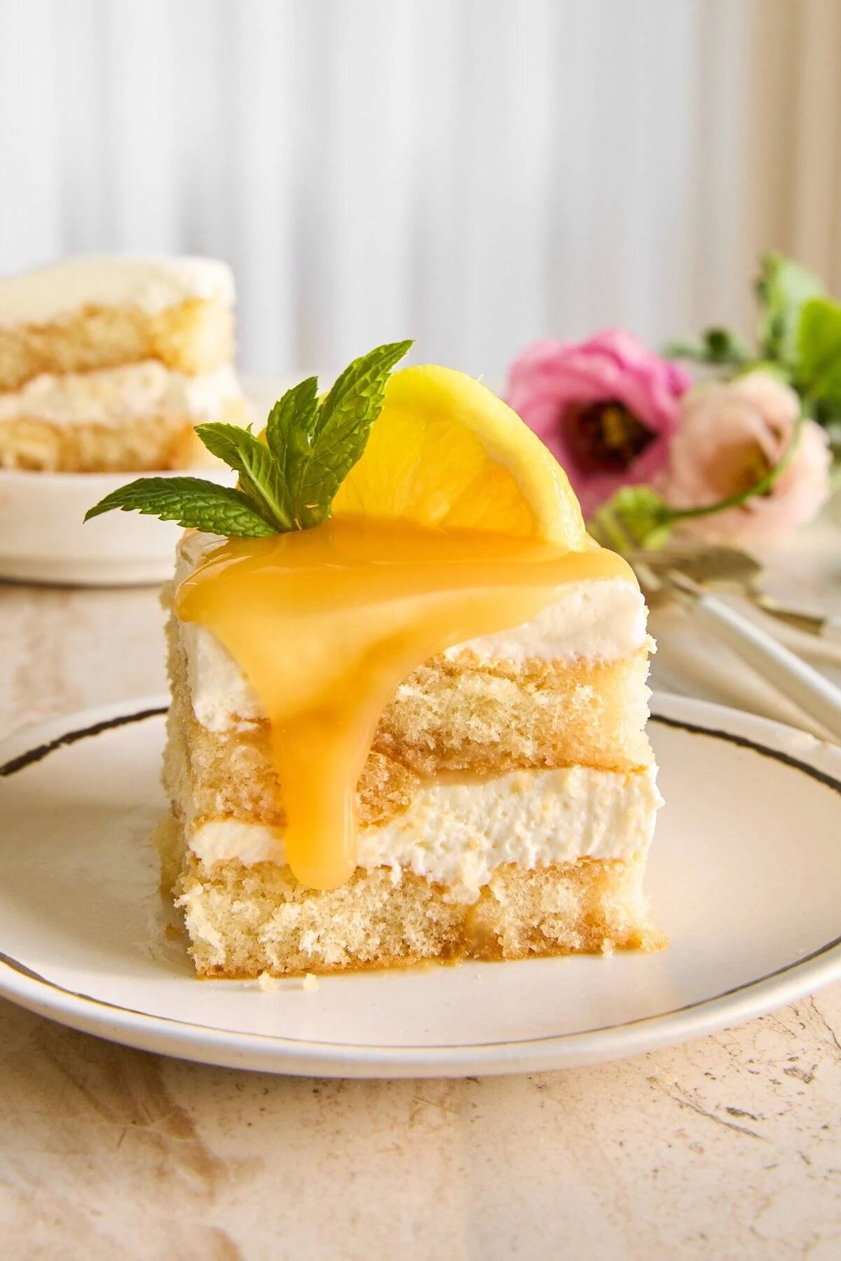 A slice of lemon tiramisu topped iwht lemon curd.