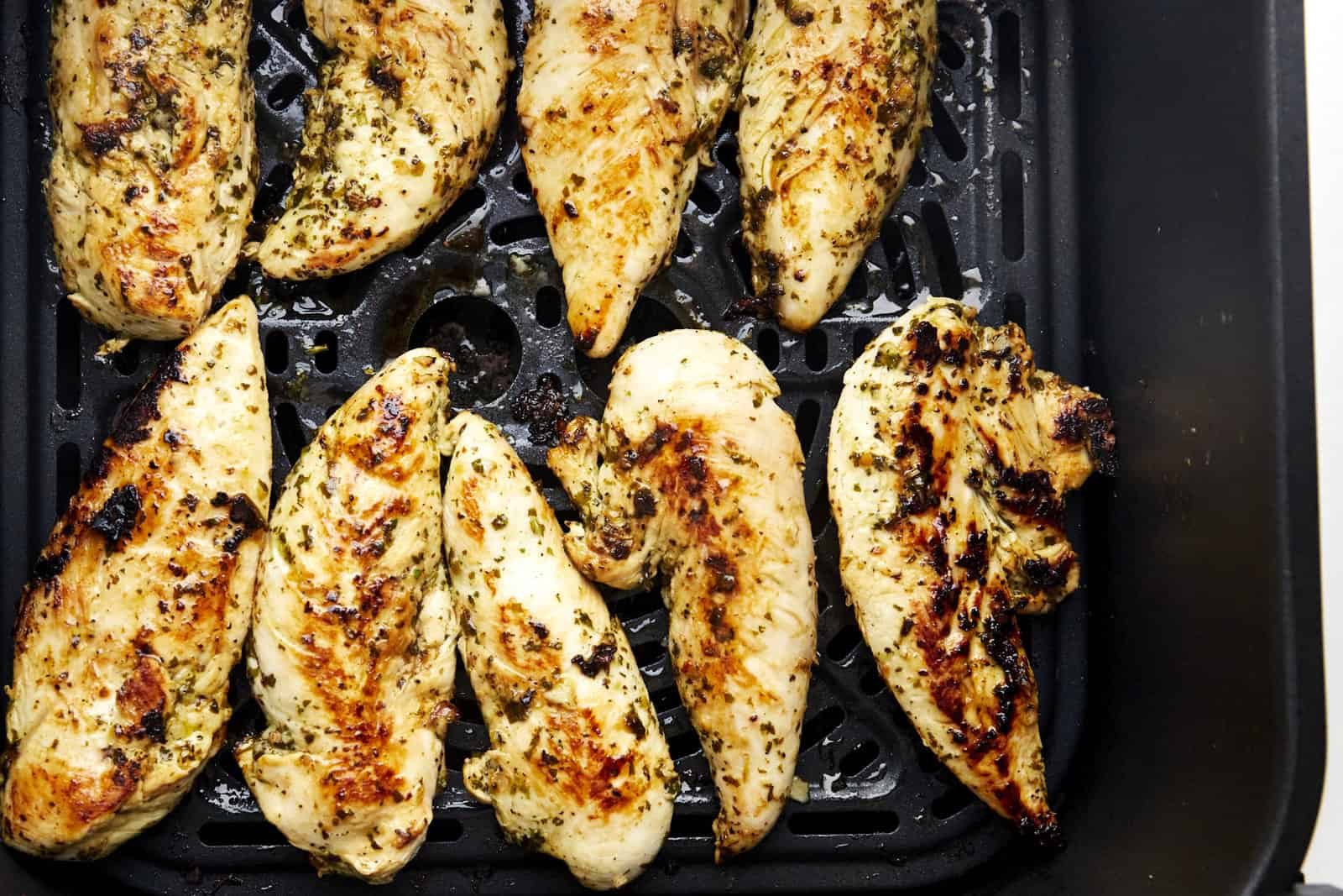 Cooked lime chicken in an air fryer basket.