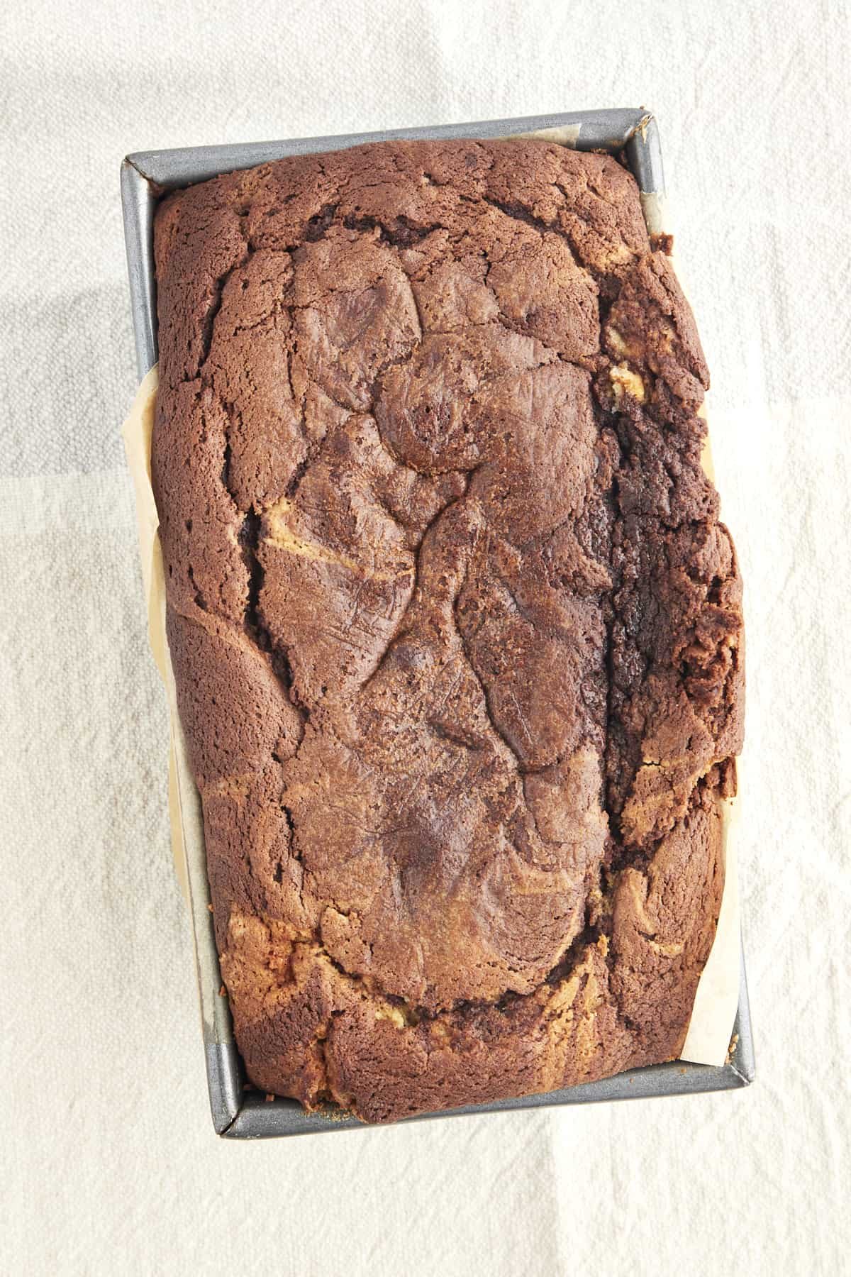 Overhead image of baked marble cake in a loaf pan.