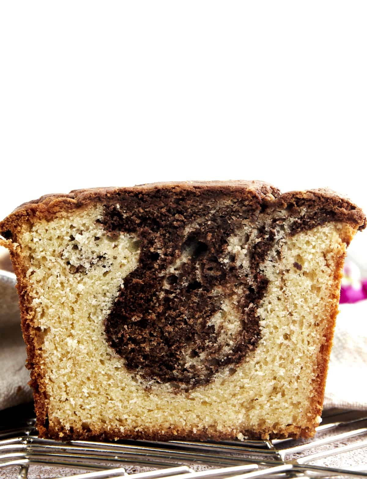 Side view of a sliced loaf of marble cake.