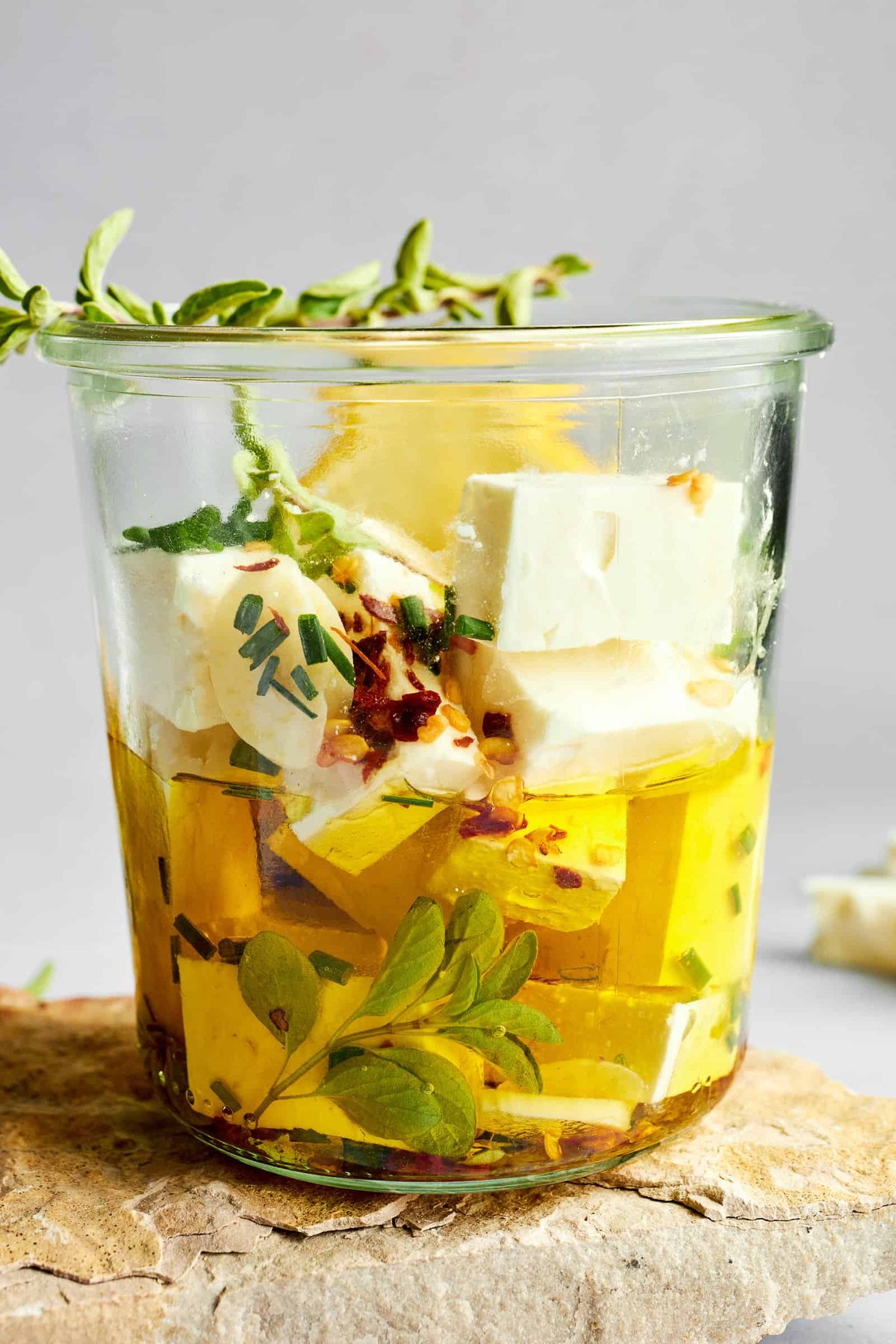 Feta cubes marinading in olive oil.