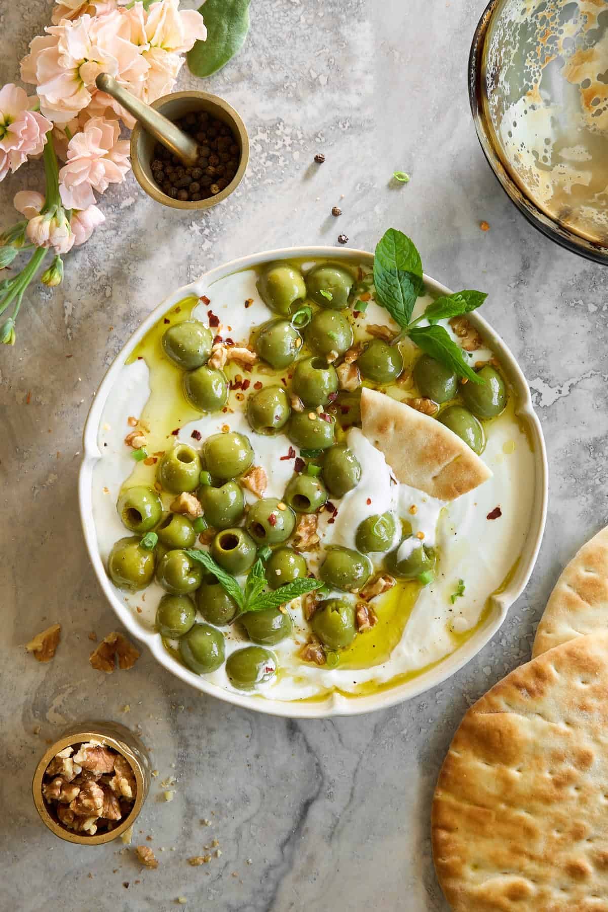 A bowl of marinated olive dip.