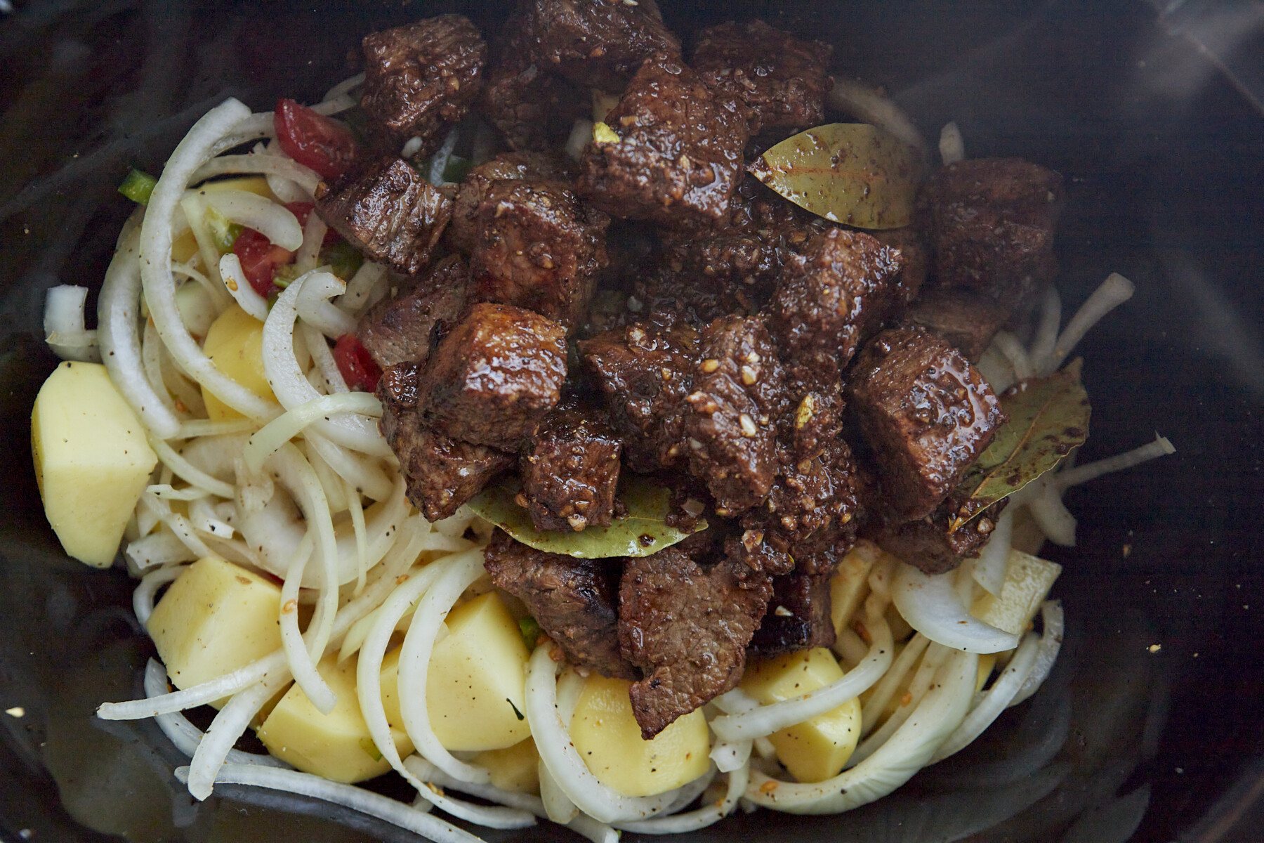 Beef stew ingredients in a crockpot.