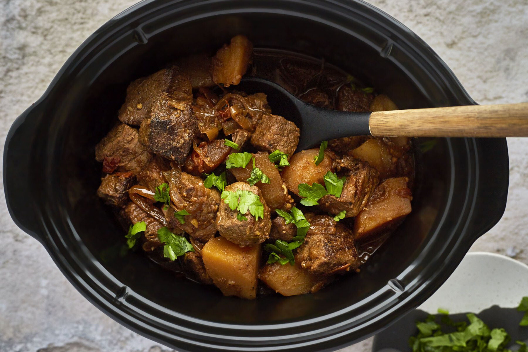 Cooked Middle Eastern beef stew in a crockpot.