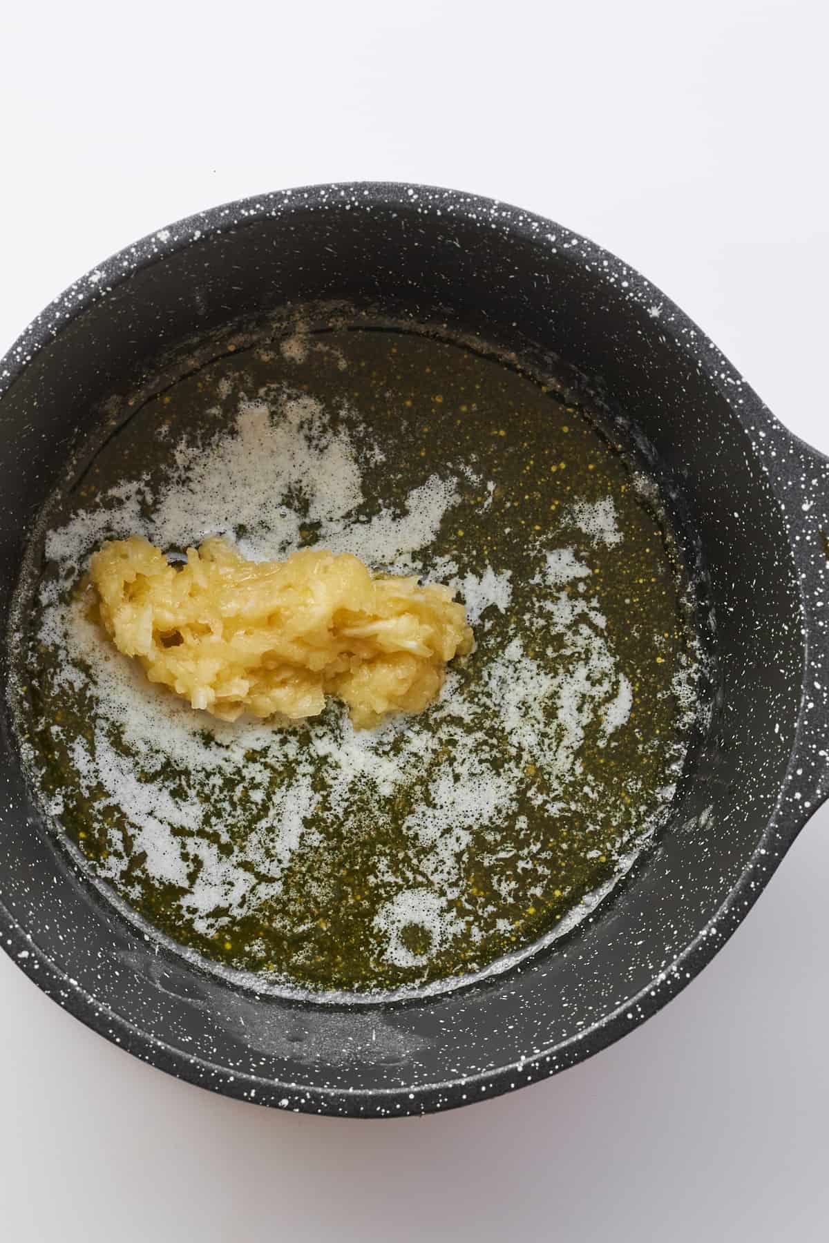Minced garlic in a pot with butter.