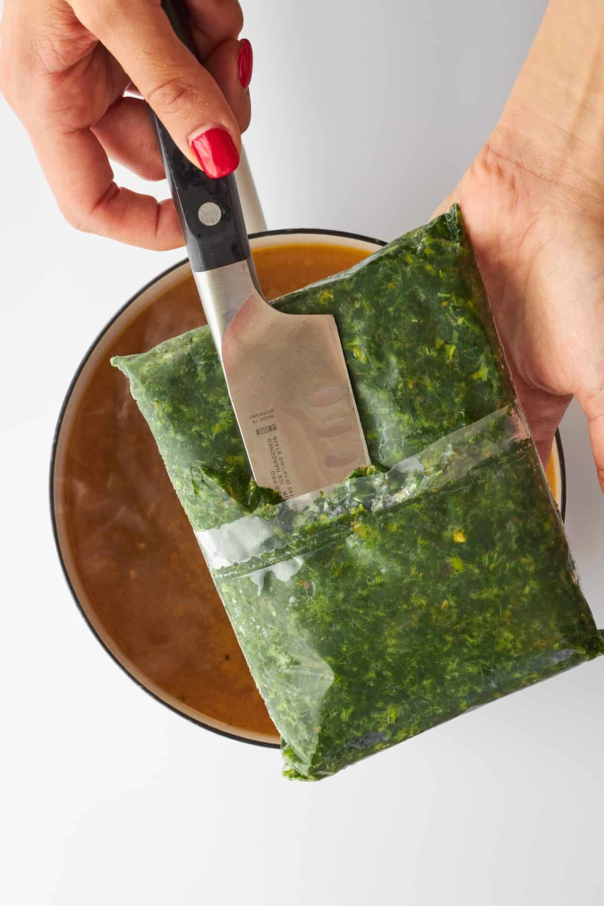 A bag of mulukhiya leaves being sliced.