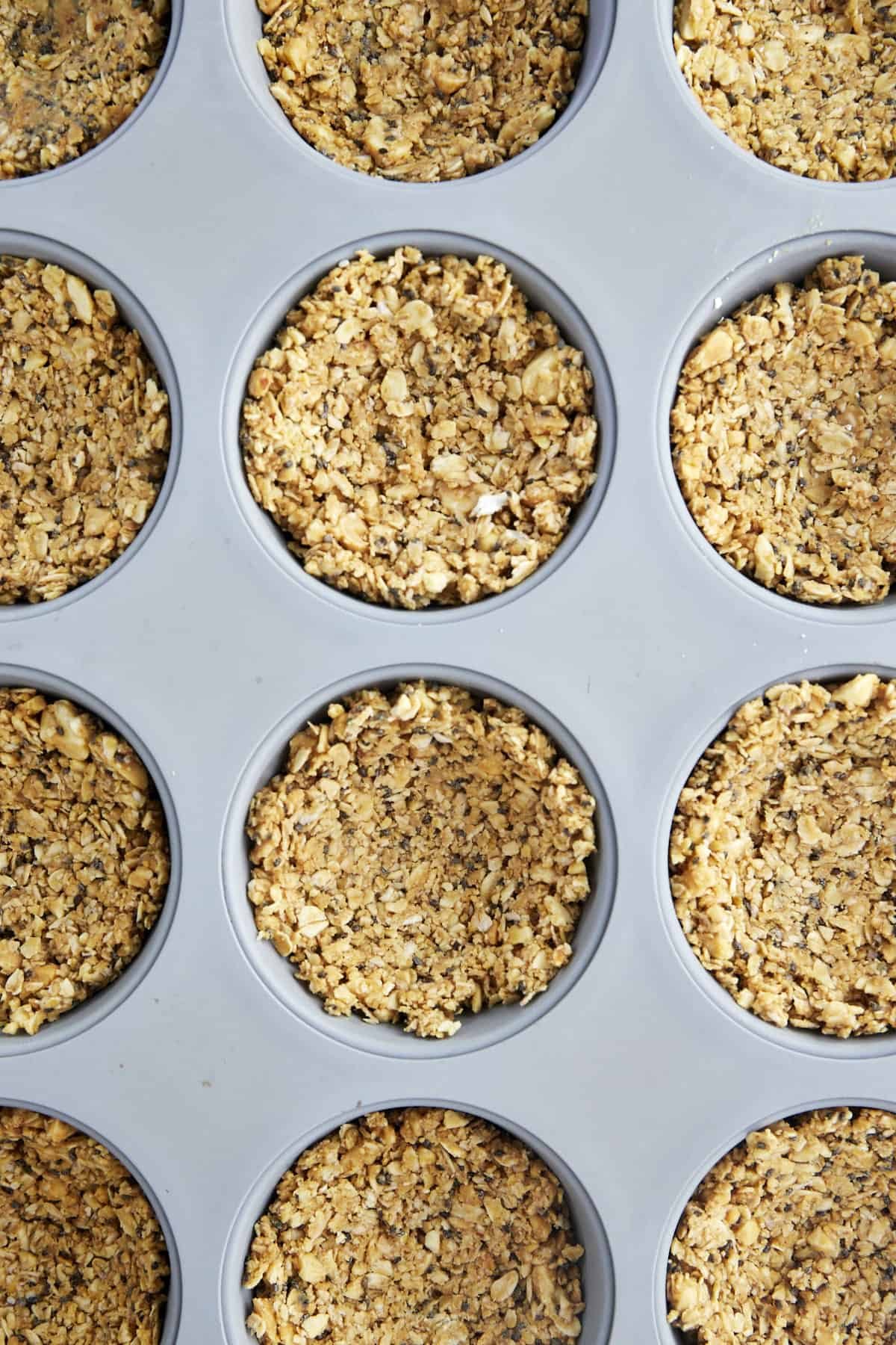 An oat mixture in a muffin pan.