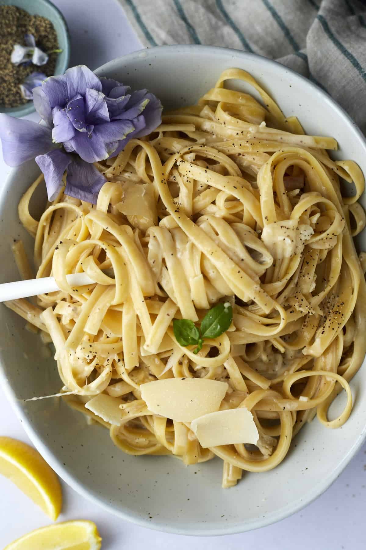 A bowl of one pot fettuccine alfredo with a fork twirled around a bite.