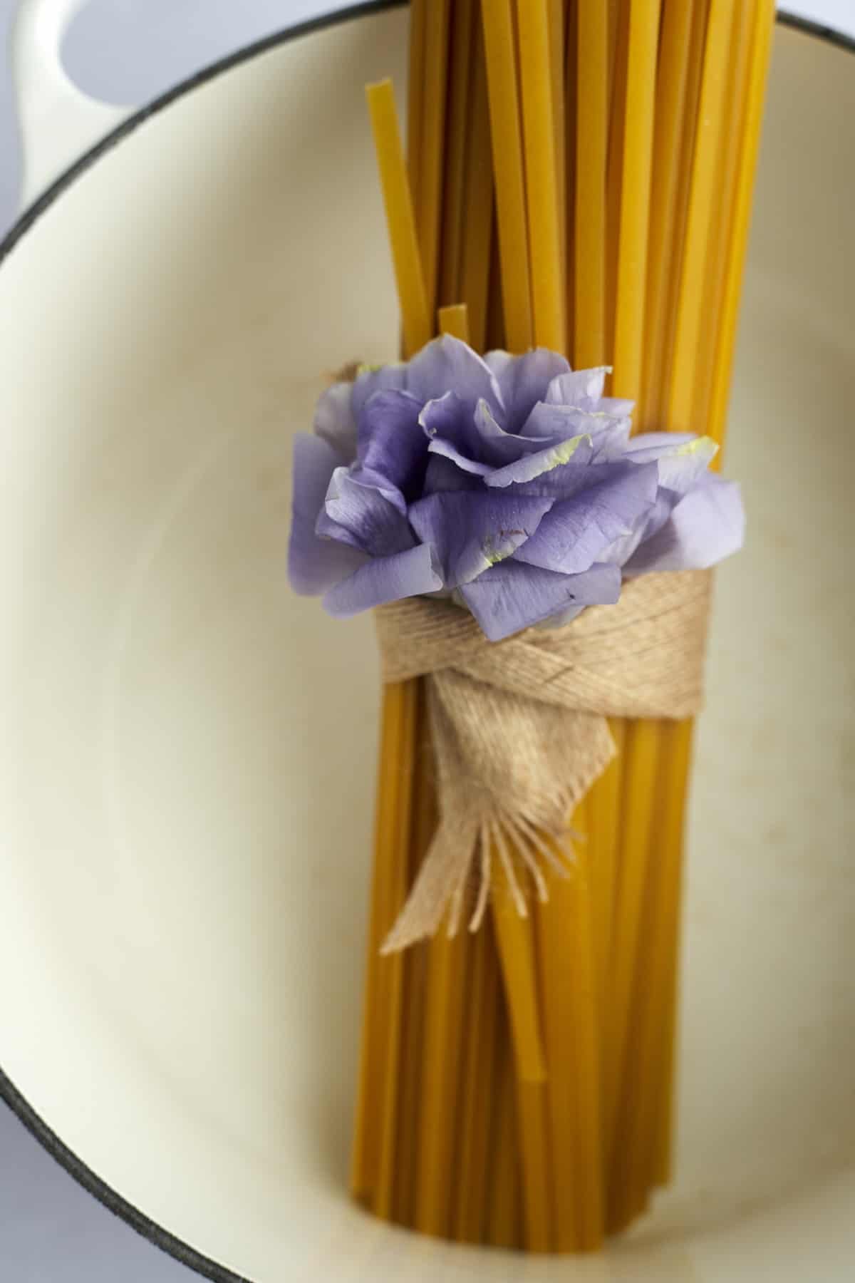 A bundle of fettuccine noodles in a pot.