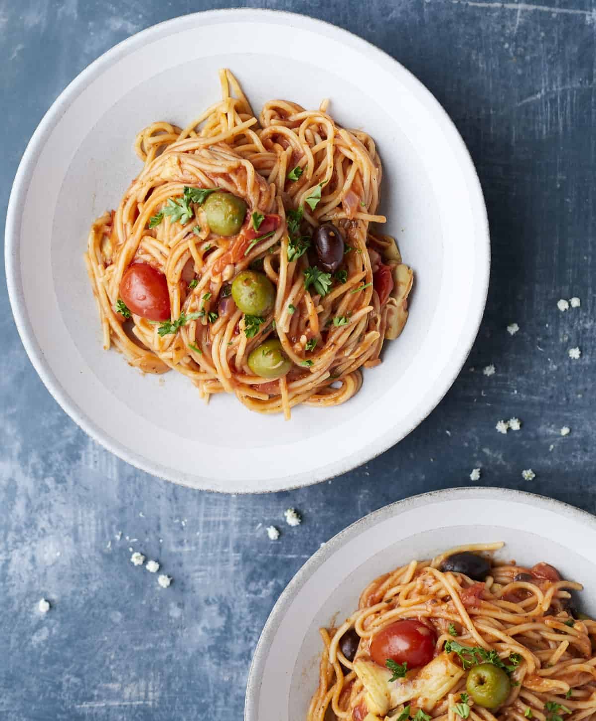 overhead image of two plates of one pot Greek spaghetti