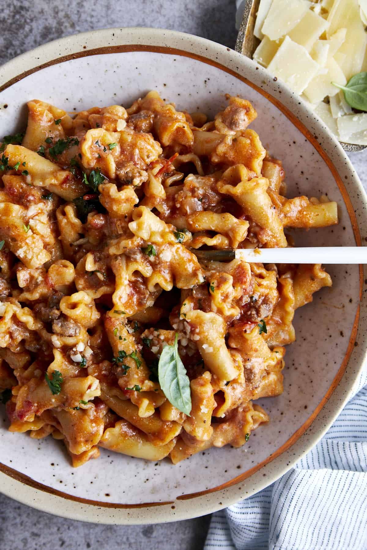Overhead image of a bowl of one pot lasagna pasta with a spoon sticking out.