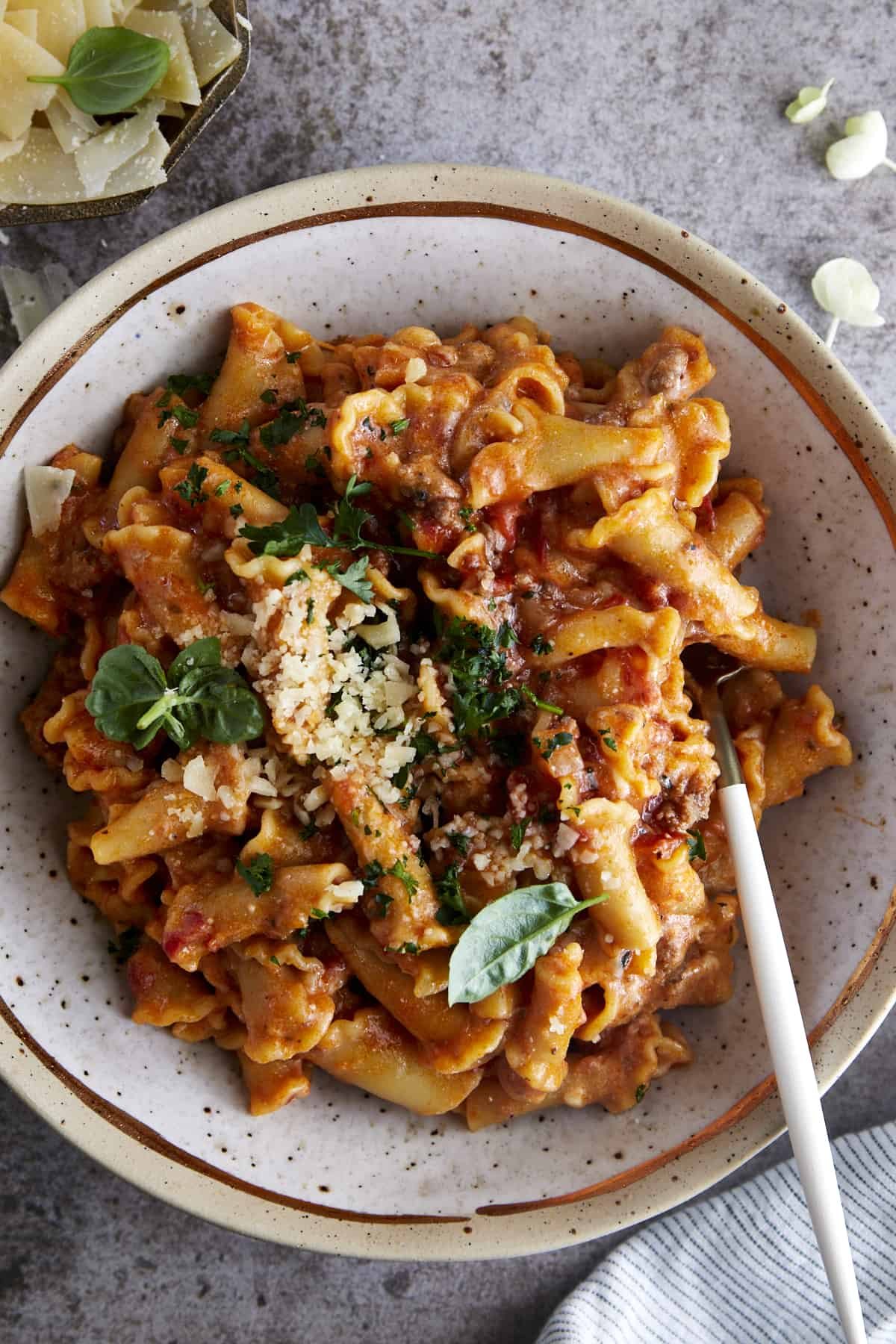 A bowl of one pot lasagna pasta topped with Parmesan cheese.