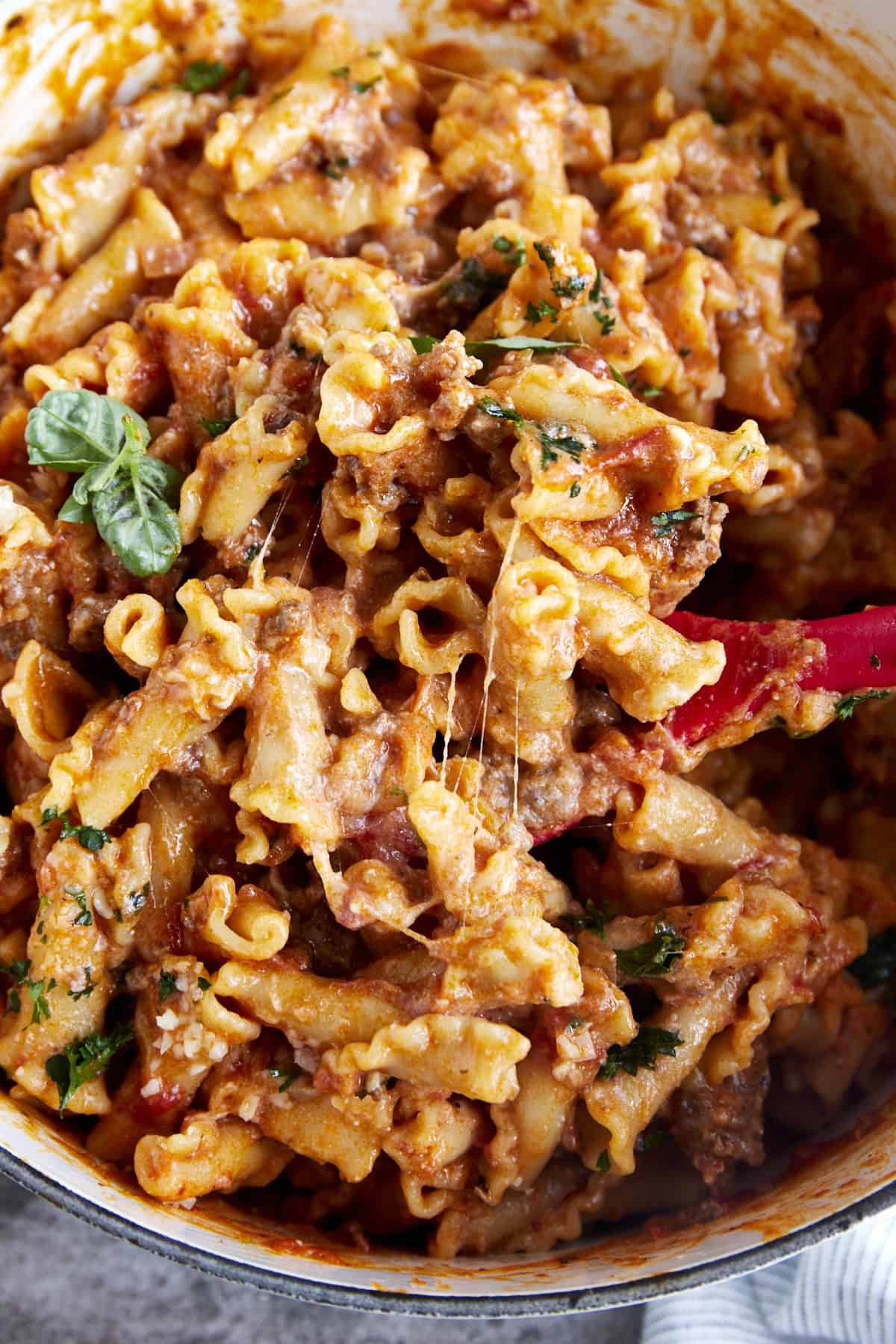 A spoon stirring cooked one pot lasagna.