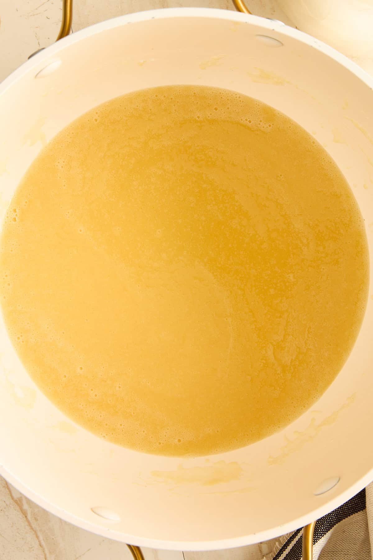 Melted butter in a pan to make a roux for macarona bechamel.