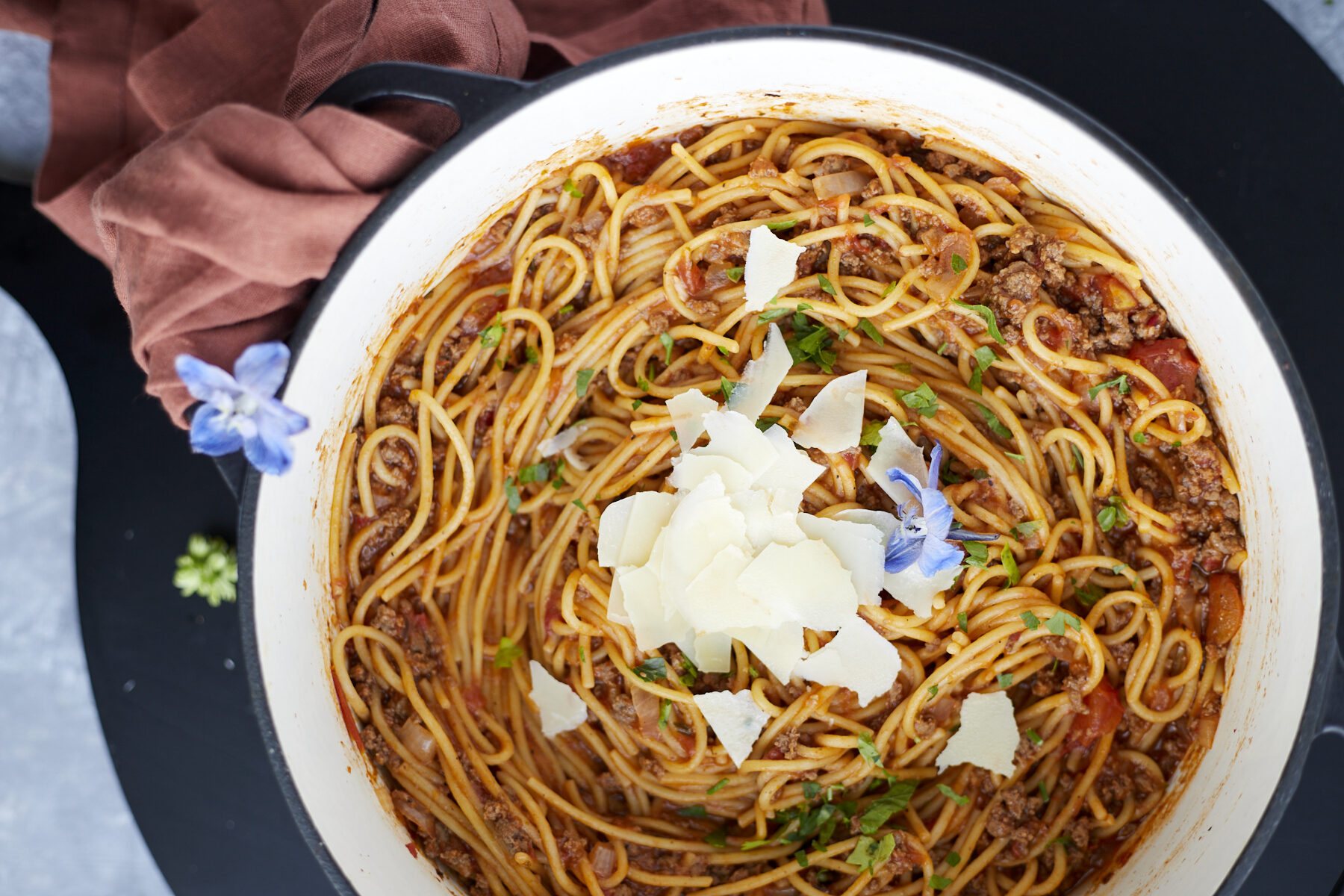 A pot full of one pot spaghetti recipe with ground beef topped with Parmesan cheese.