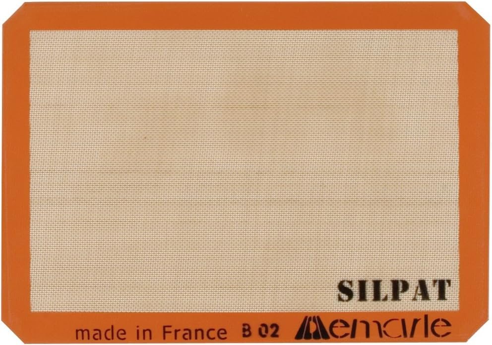 Silpat mat with an orange border.