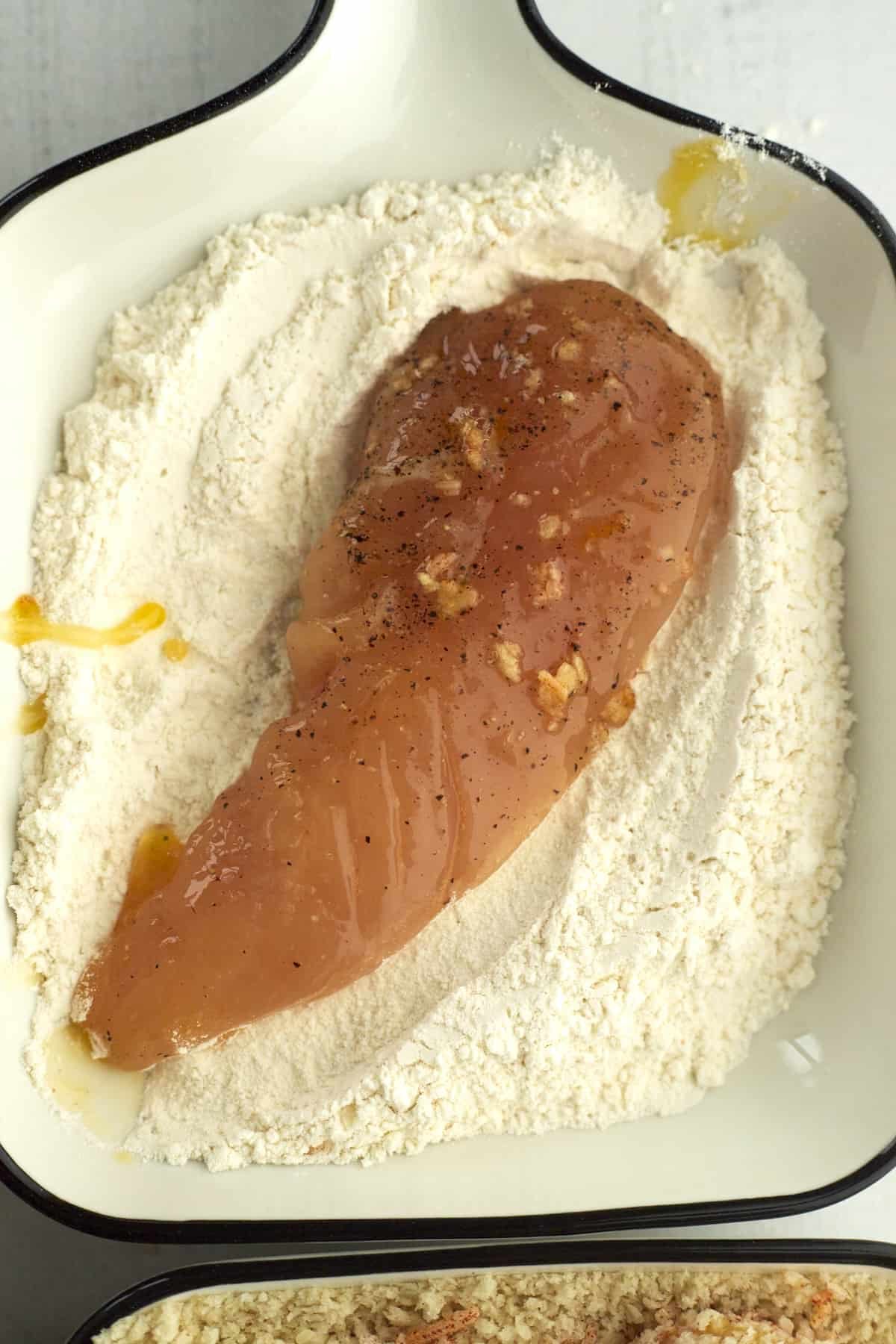 chicken being dipped in flour