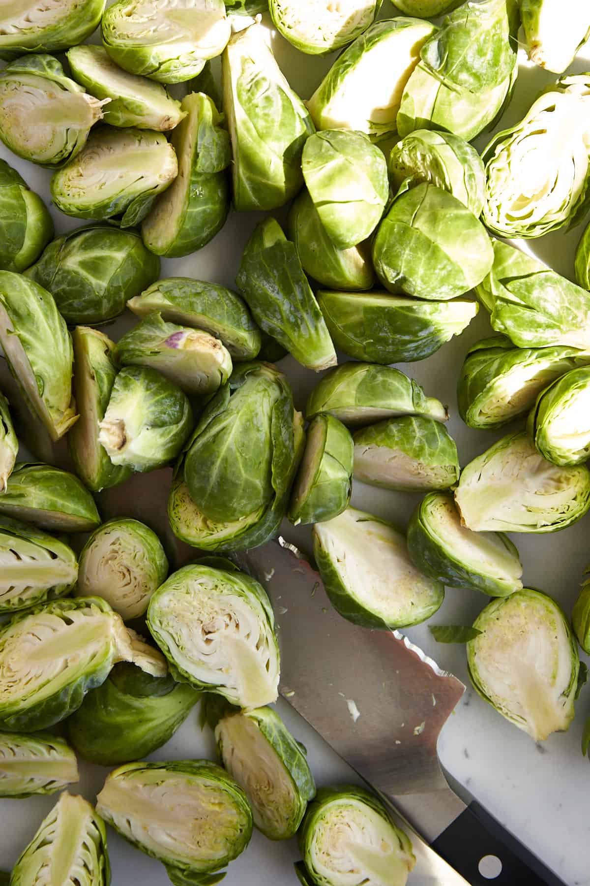 Raw Brussels sprouts sliced in half.