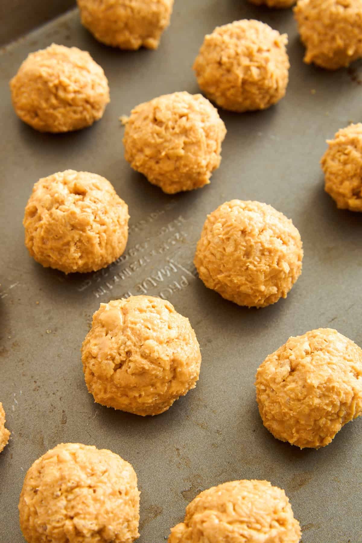 Peanut Butter Balls with Rice Krispies on a baking sheet.