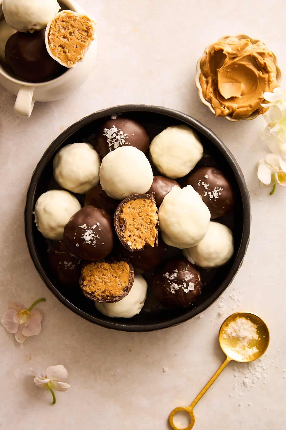 A bowl of Peanut Butter Balls with Rice Krispies with white and dark chocolate coating.