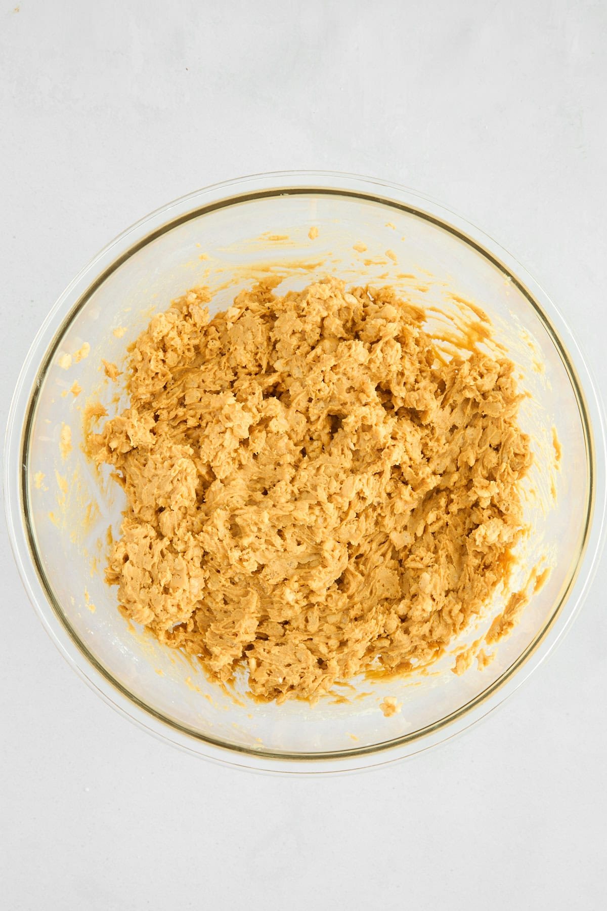 Peanut Butter Balls with Rice Krispies batter in a bowl.