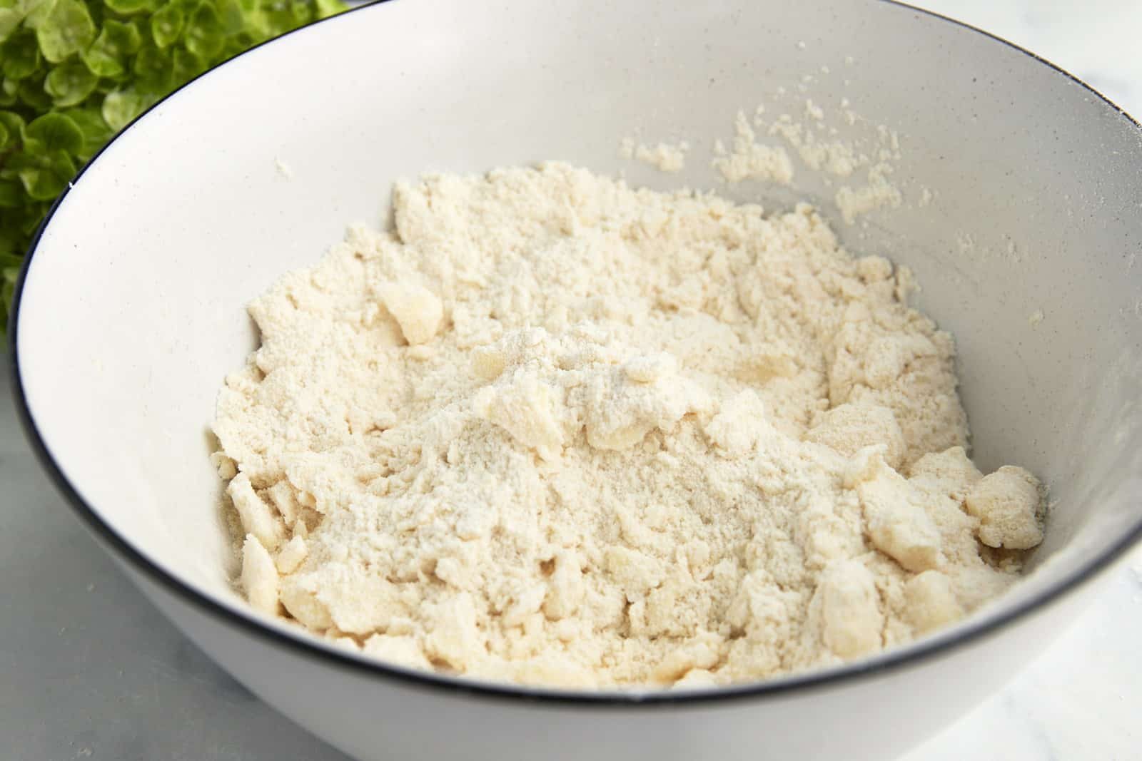 Butter cut into a bowl of flour.