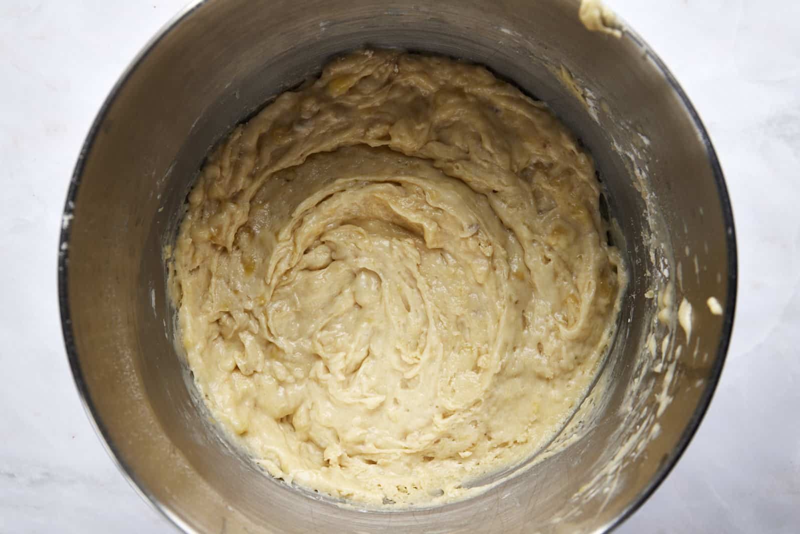 Banana bread batter in a large mixing bowl.