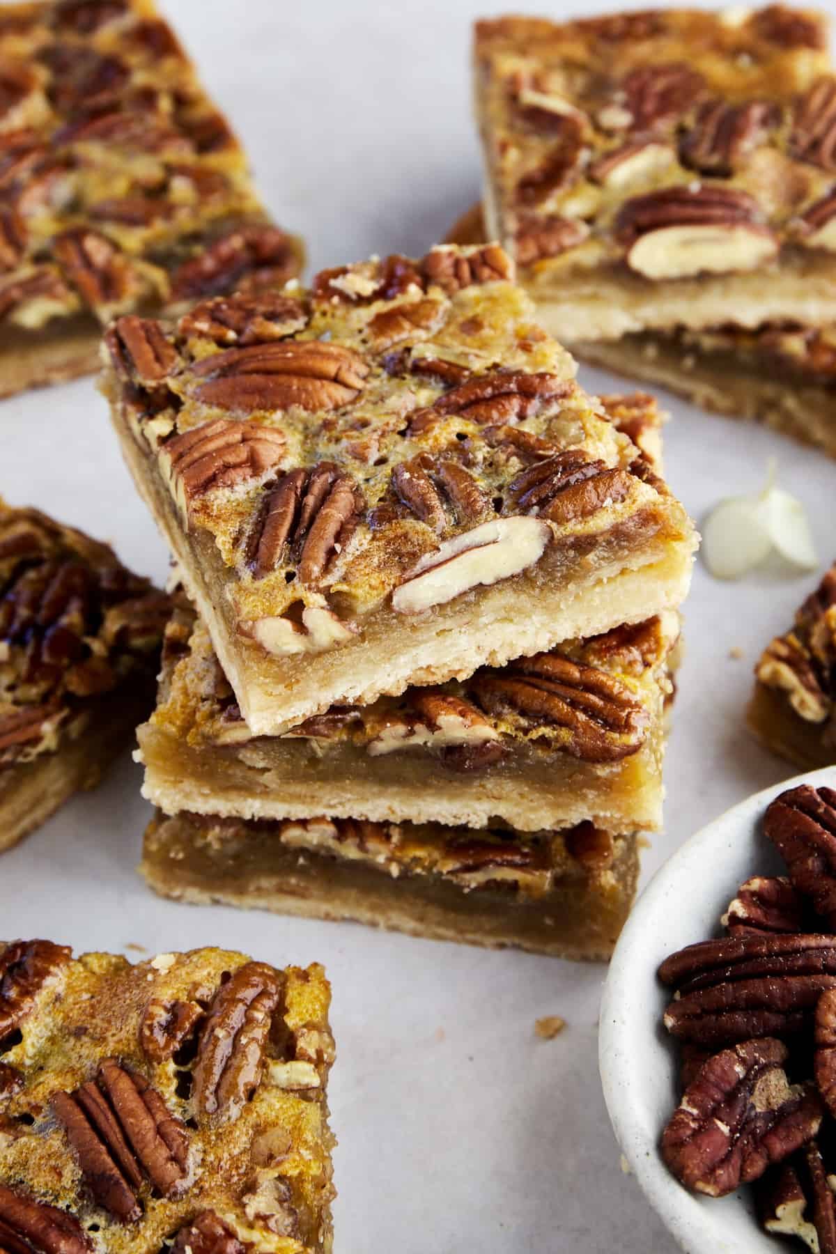 Simple pecan pie bars stacked on top of each other.