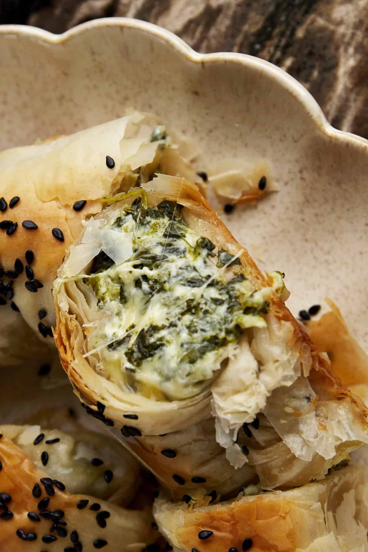 The filling of a phyllo spanakopita roll.