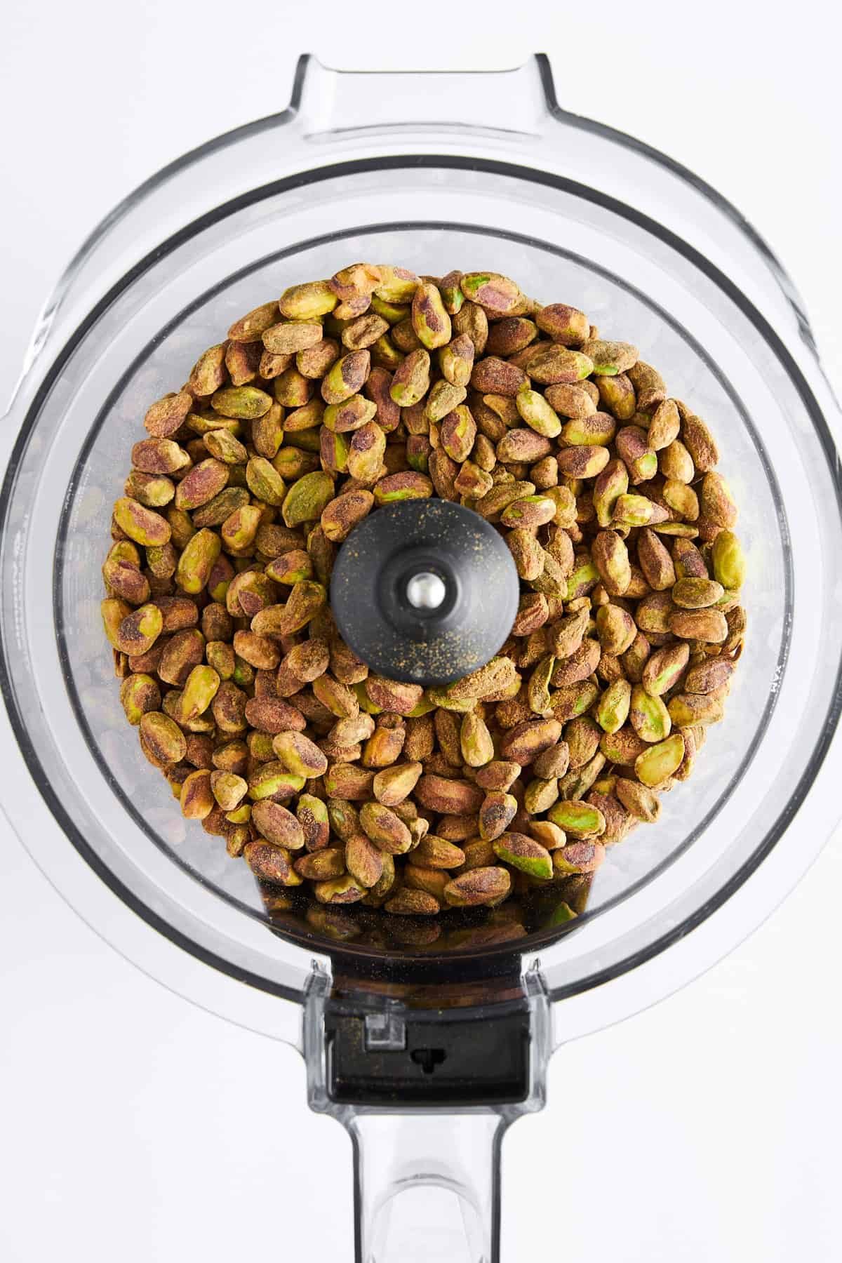 Shelled pistachios in a food processor.