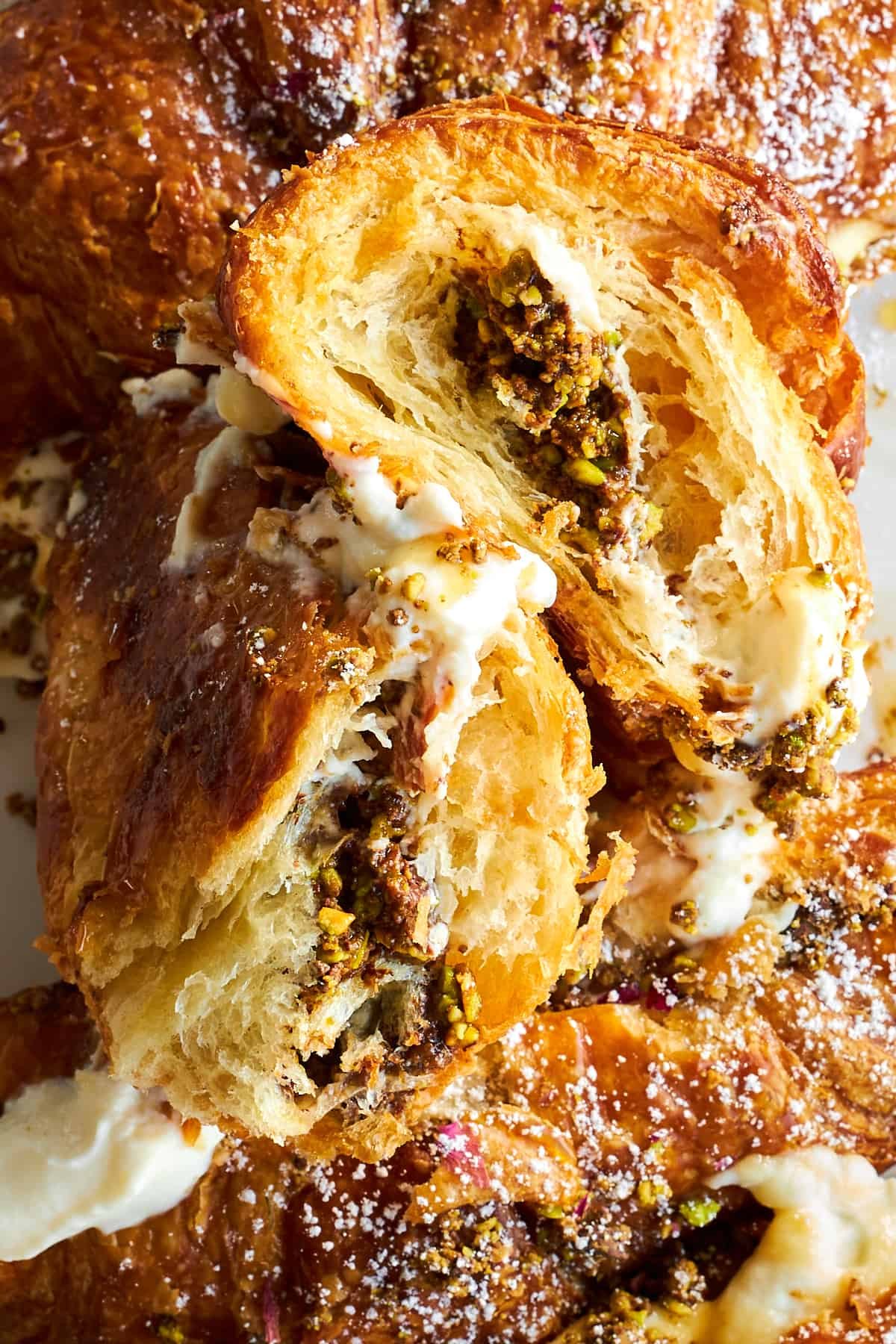 Close up image of halved Chocolate Pistachio Croissants with Ricotta.