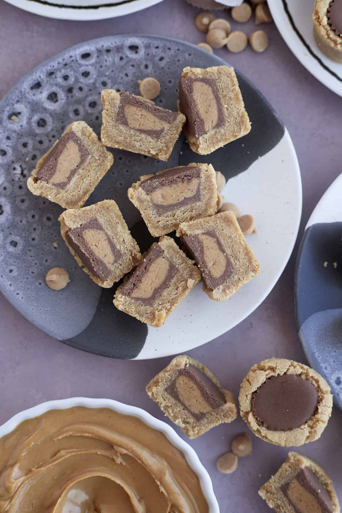 overhead image of a plate full of Reese's peanut butter cup cookies sliced in half