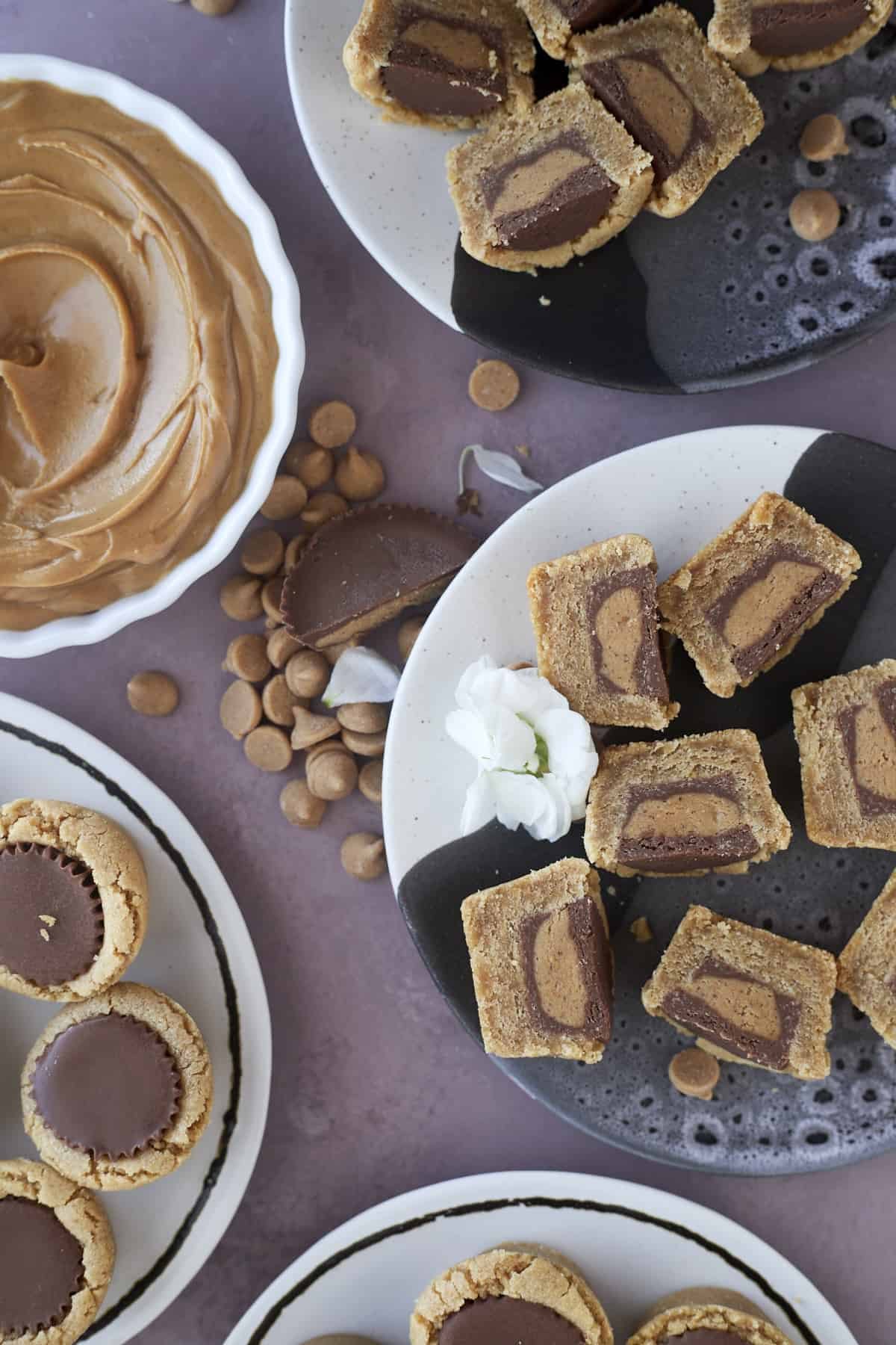 four plates of Reese's peanut butter cup cookies with some sliced in half