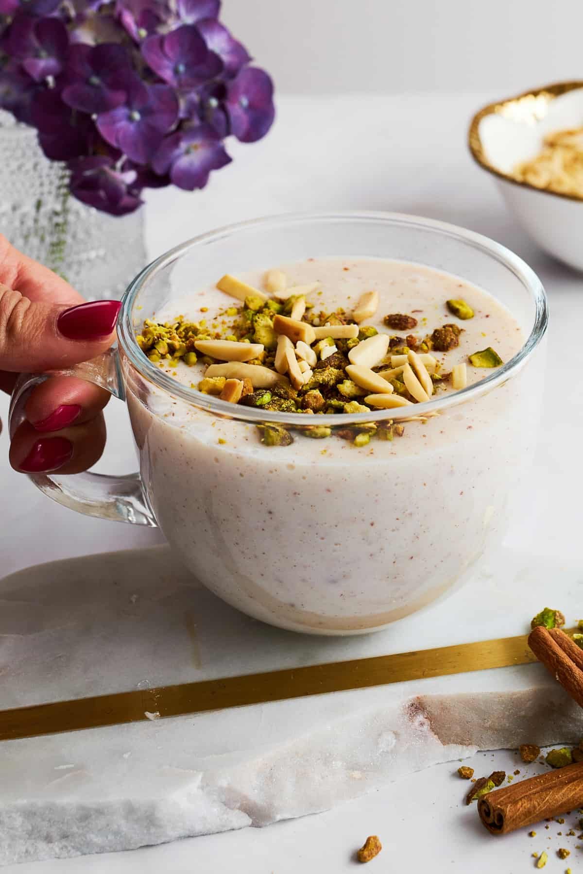 A mug of Sahlab topped with nuts.