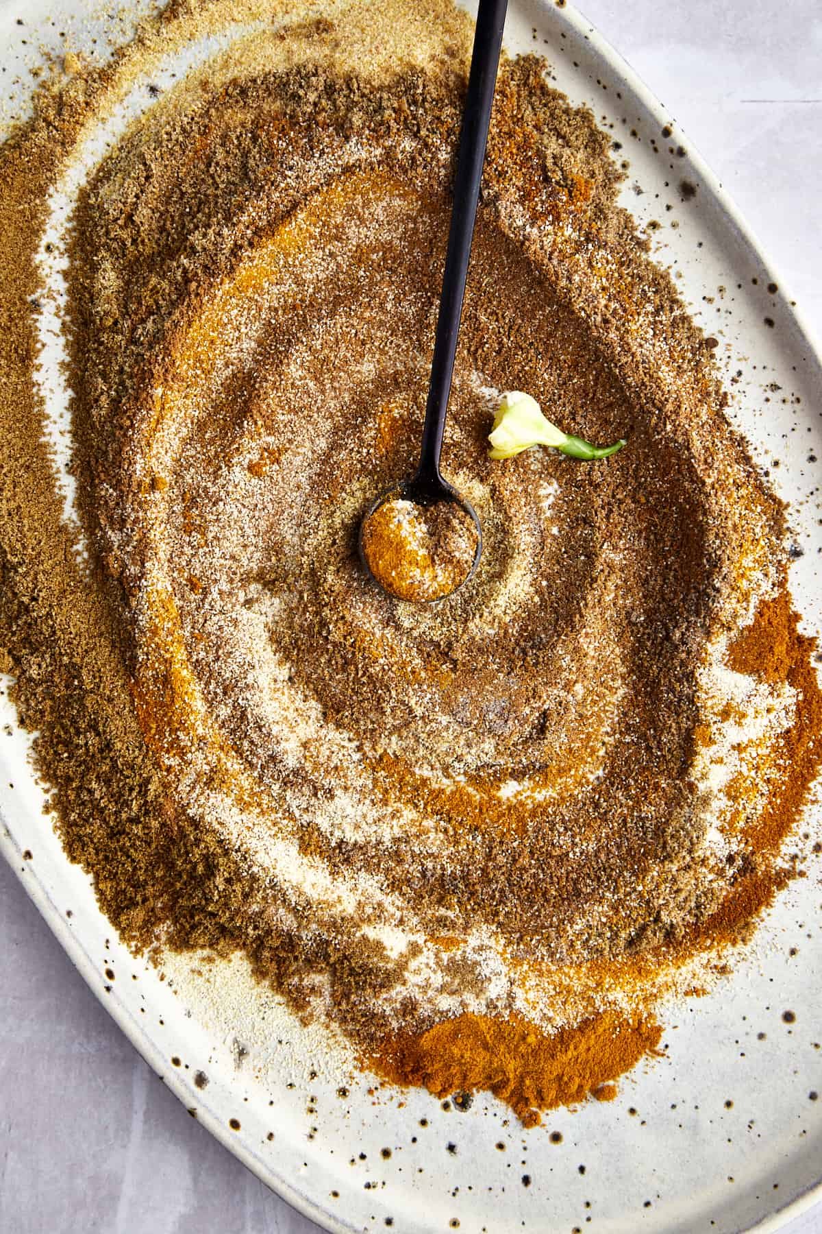 Shawarma spices being mixed together to make a DIY shawarma seasoning blend.